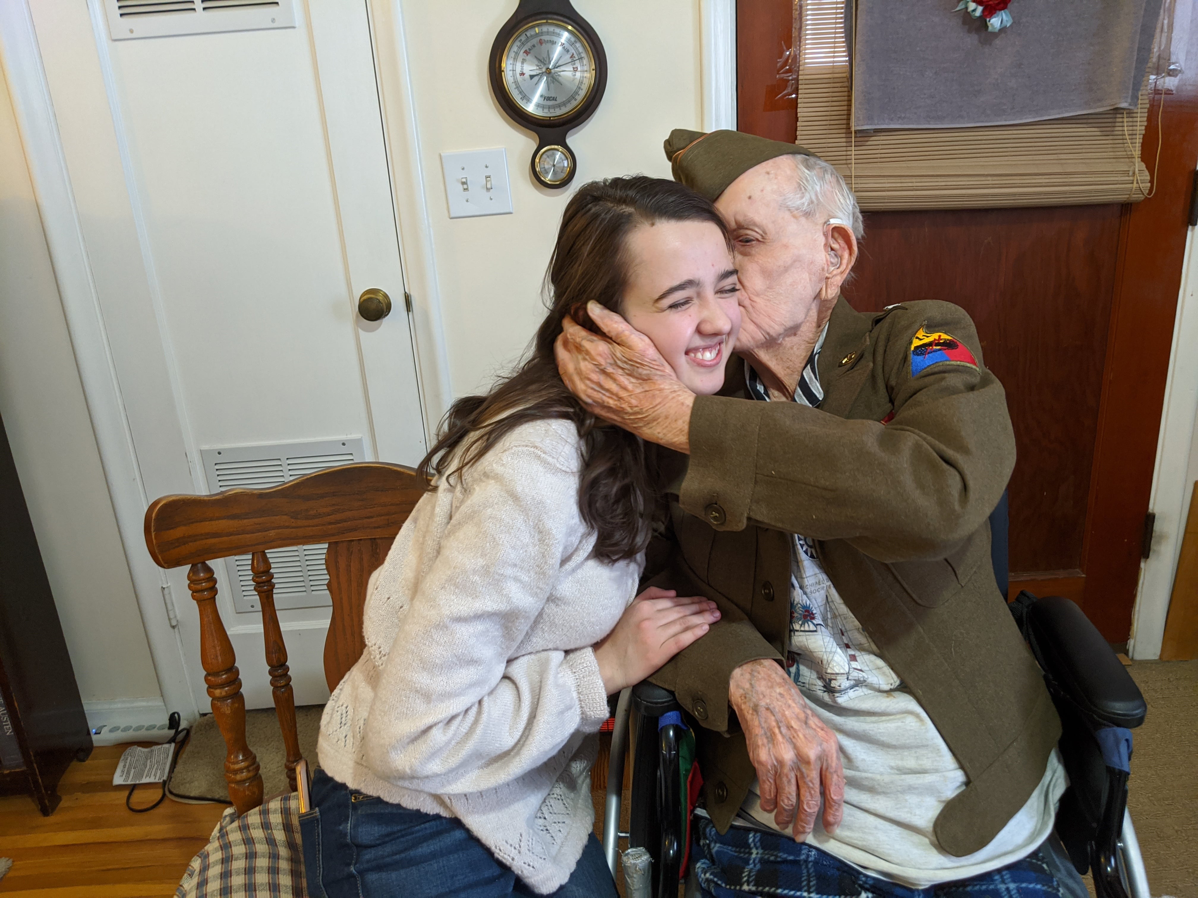 The late Staff Sgt. Stanley Nance kissing his great-granddaughter, Madeline Christianson, at Nance’s home in Millcreek in September 2021, months before his passing.