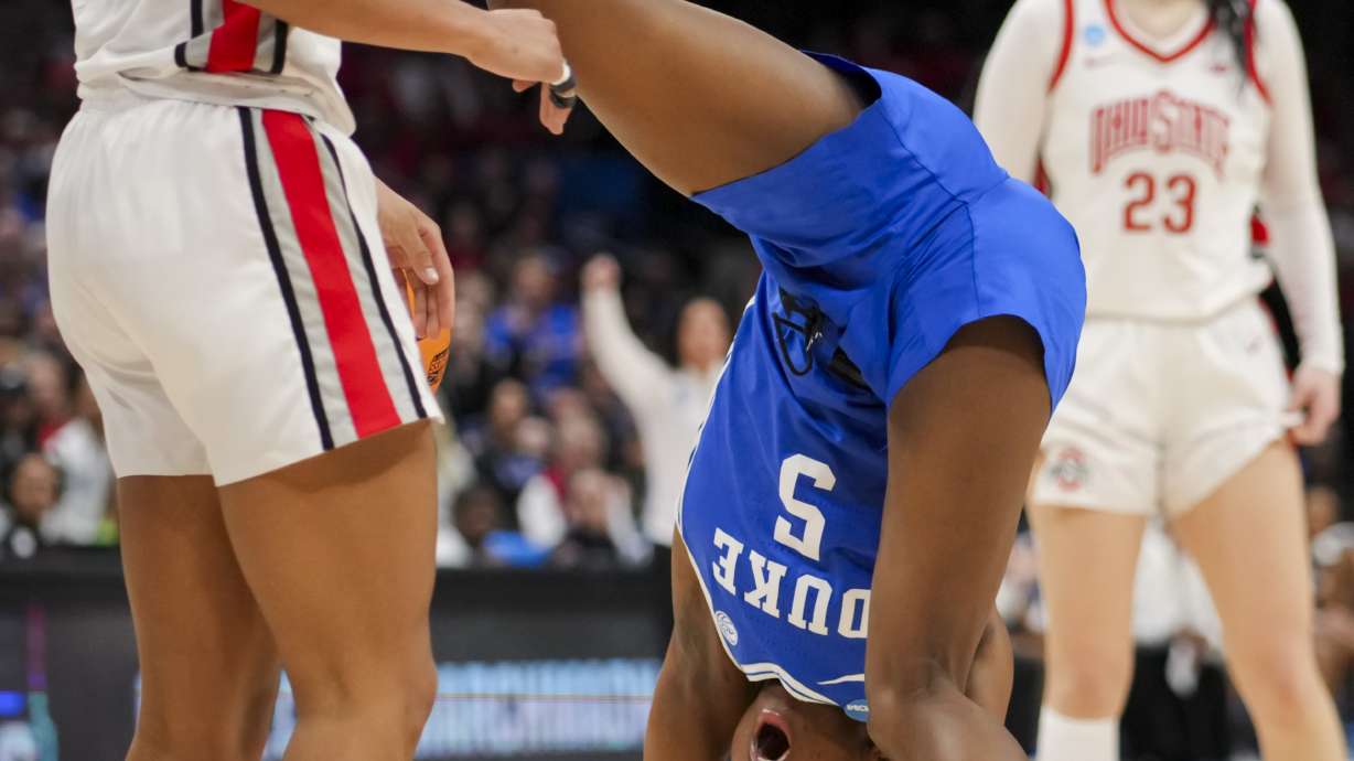 Duke guard Oluchi Okananwa, front right, tumbles after colliding with Ohio State guard Taylor Thierry, left, during the first half of a second-round college basketball game in the women's NCAA Tournament, Sunday, March 24, 2024, in Columbus, Ohio.
