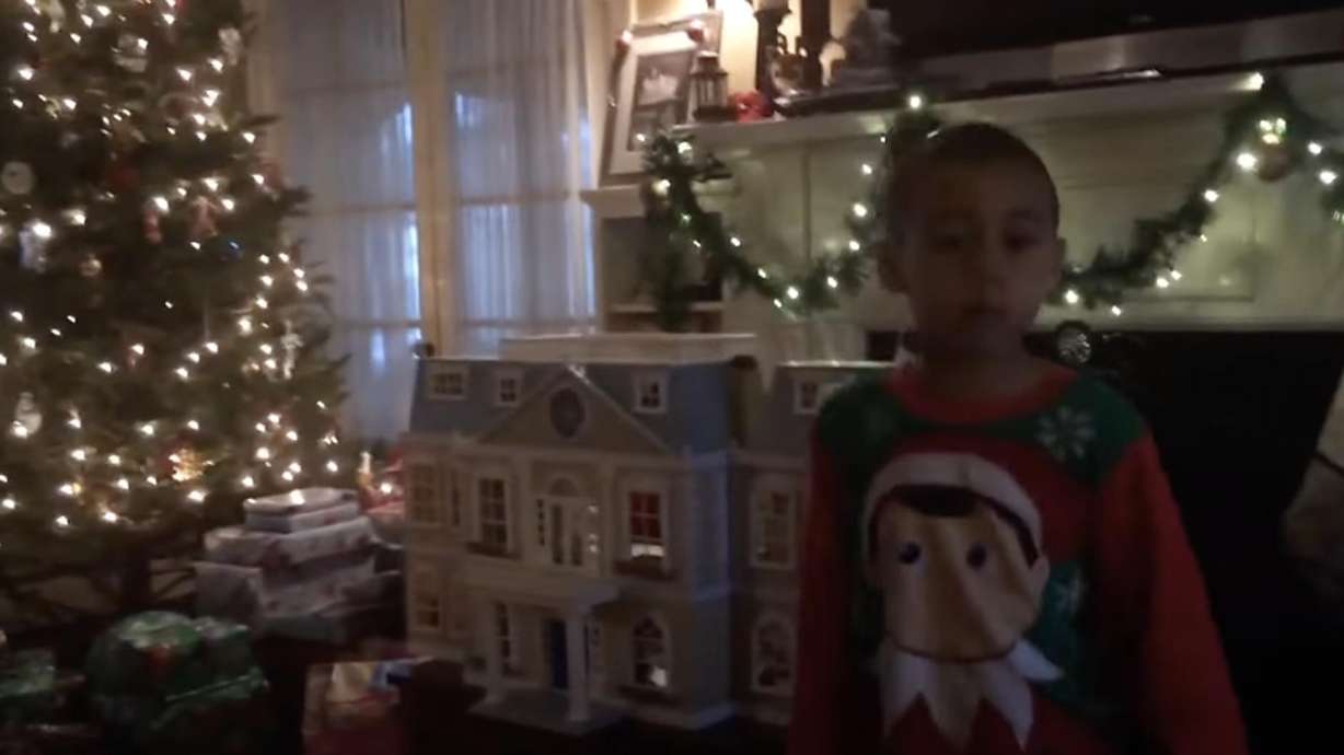 A young boy accidentally breaks his tot sister's dollhouse when he drives into it with the toy Power Wheels motorcycle he got for Christmas.