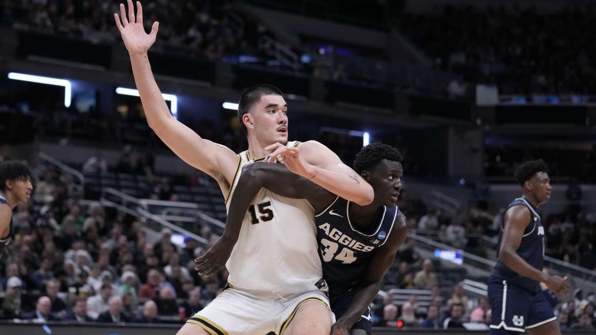 Purdue's Zach Edey (15) looks for a pass under the basket as Utah State's Kalifa Sakho (34) defends during the second half of a second-round college basketball game in the NCAA Tournament, Sunday, March 24, 2024 in Indianapolis.
