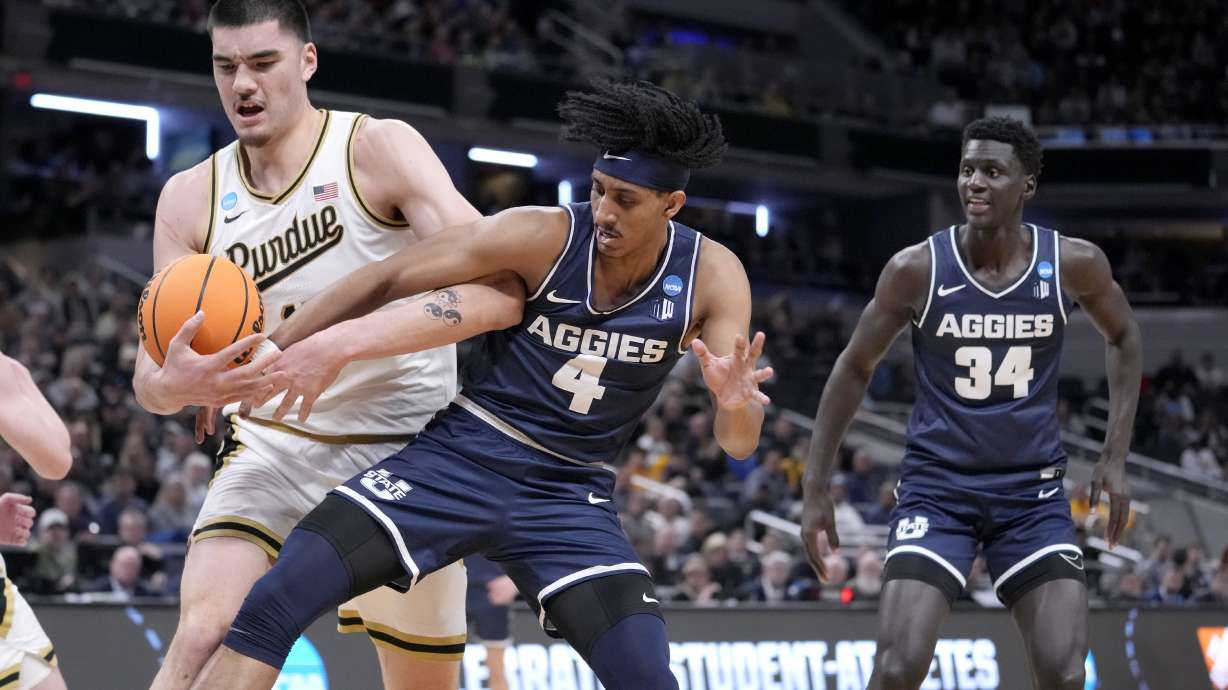 Purdue's Zach Edey, left, and Utah State's Ian Martinez battle for the ball as Utah State's Kalifa Sakho (34) watches during the first half of a second-round college basketball game in the NCAA Tournament, Sunday, March 24, 2024 in Indianapolis.