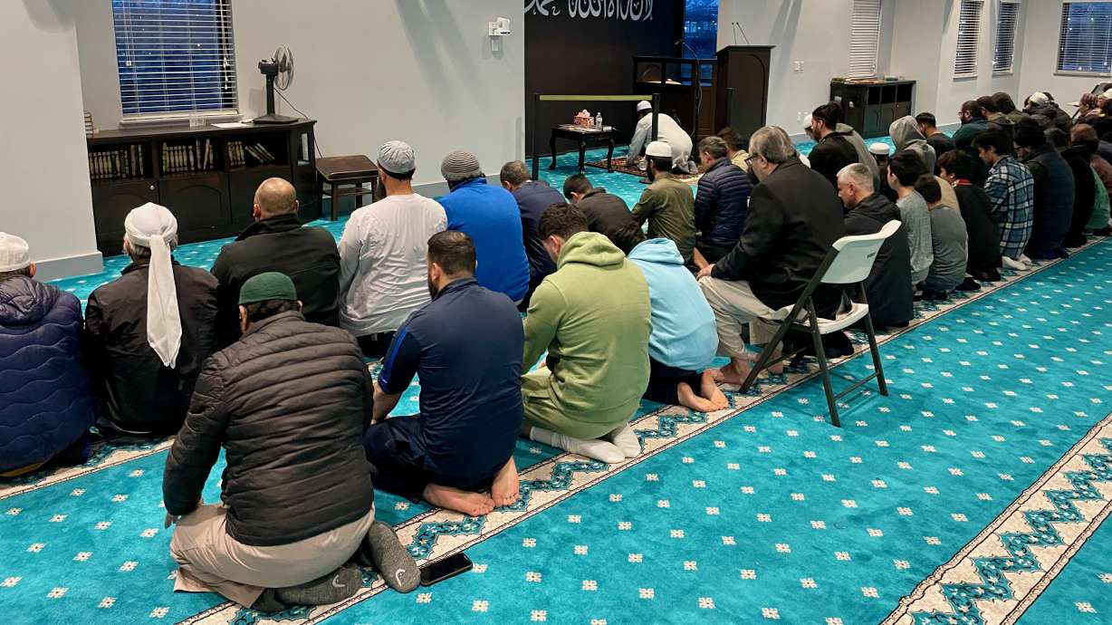Imam Shuaib Din, at the front in the photo, leads prayer at the Utah Islamic Center in West Jordan on March 24, 2024. Din's car was fired on in an incident Monday, and police are investigating the incident as a possible hate crime.