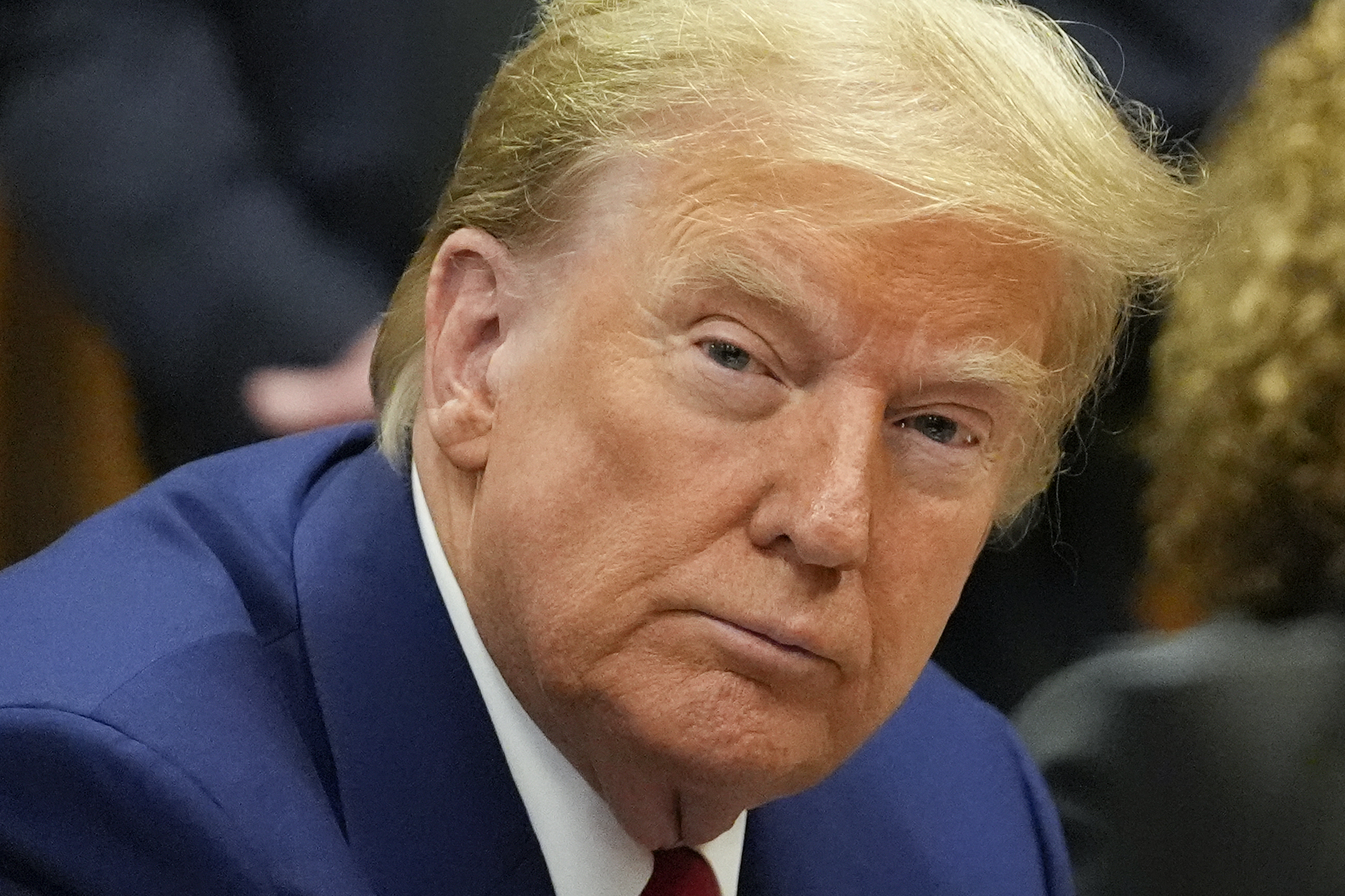 Former President Donald Trump awaits the start of a pre-trial hearing with his defense team at Manhattan criminal, Monday, in New York. A judge will weigh on Monday when the former president will go on trial.