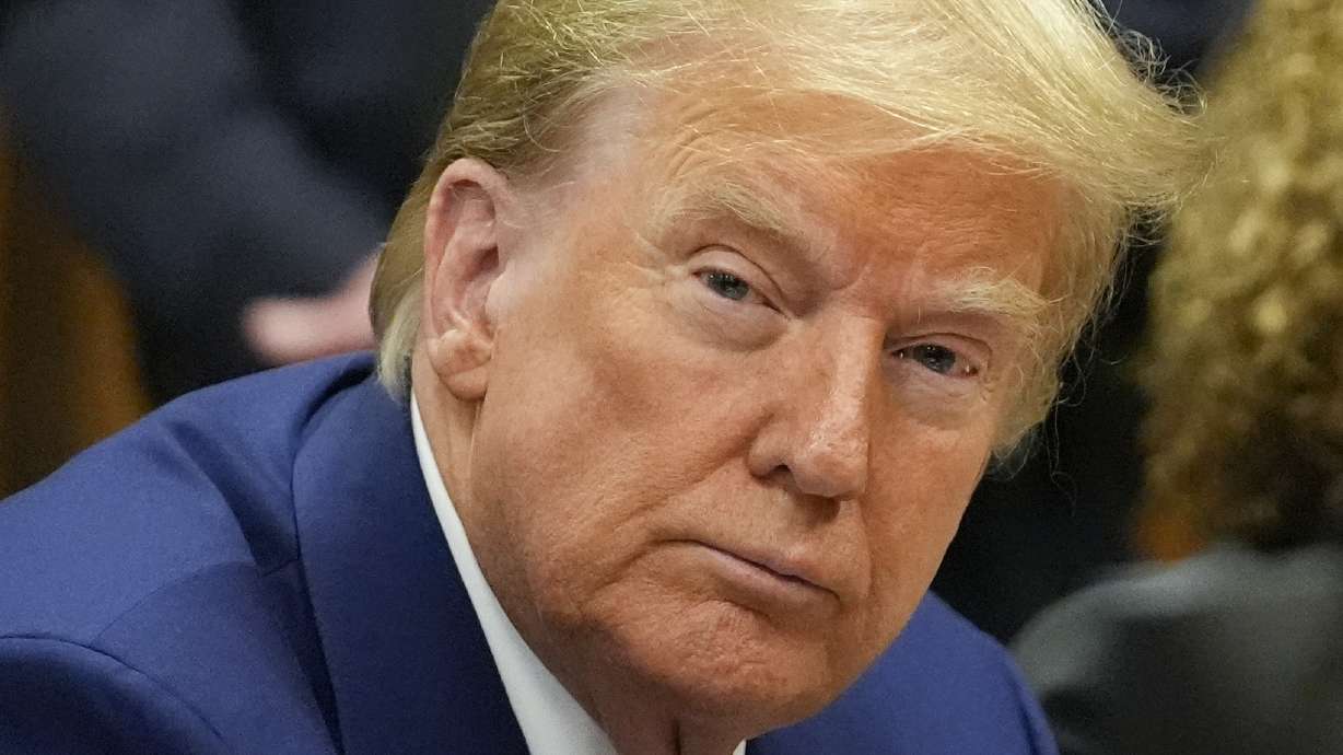 Former President Donald Trump awaits the start of a pre-trial hearing with his defense team at Manhattan criminal, Monday, in New York. A judge will weigh on Monday when the former president will go on trial.