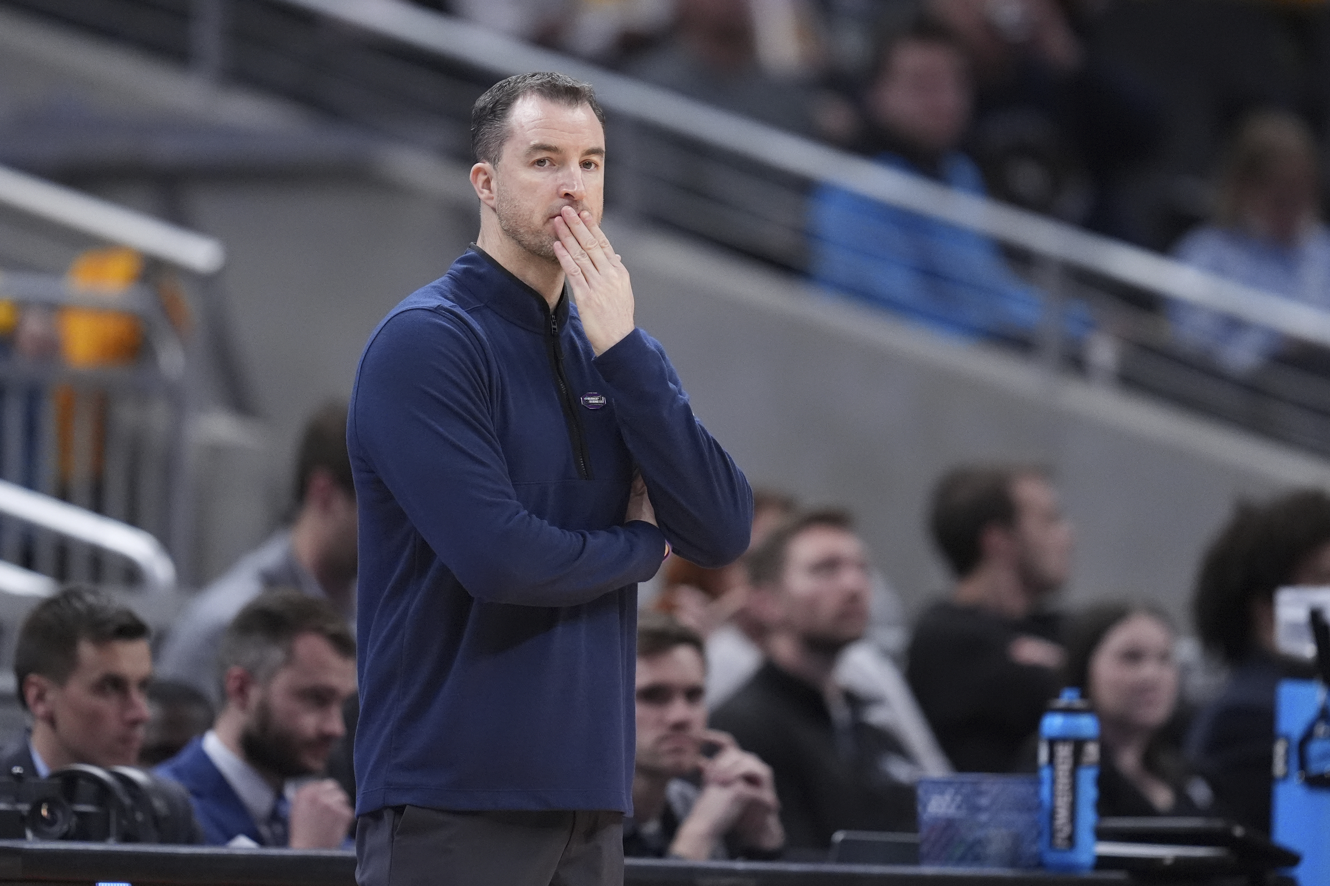 Utah State head coach Danny Sprinkle is seen on the sidelines during the first half of a second-round college basketball game against Purdue in the NCAA Tournament, Sunday, March 24, 2024 in Indianapolis.