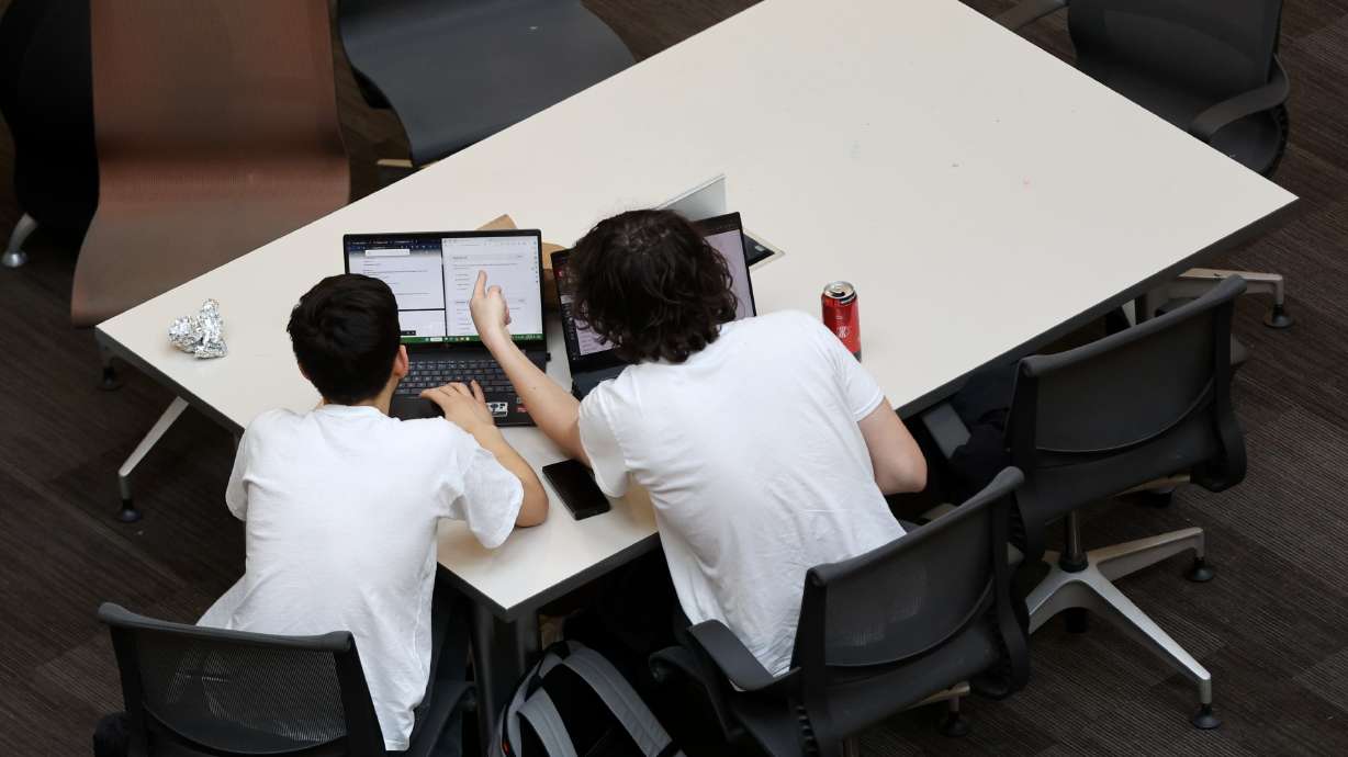 People study in the J. Willard Marriott Library at the University of Utah in Salt Lake City on March 13. A new degree program being developed for Utah's public institutions would allow students to graduate with a bachelor's degree in three years.