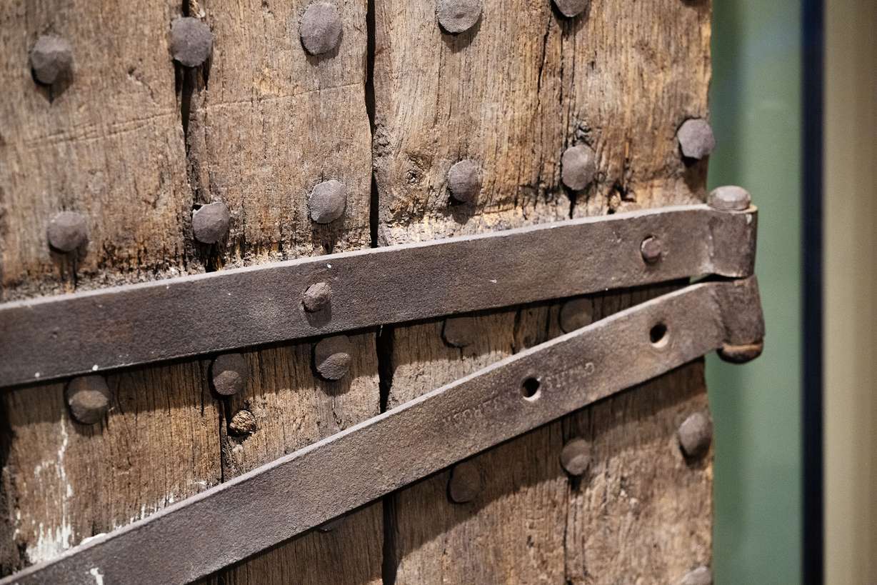 A section of the door and one of the hinge straps on the Liberty Jail door are on display during a preview of some of the artifacts newly transferred from the Community of Christ, at the Church History Museum in Salt Lake City on Monday.