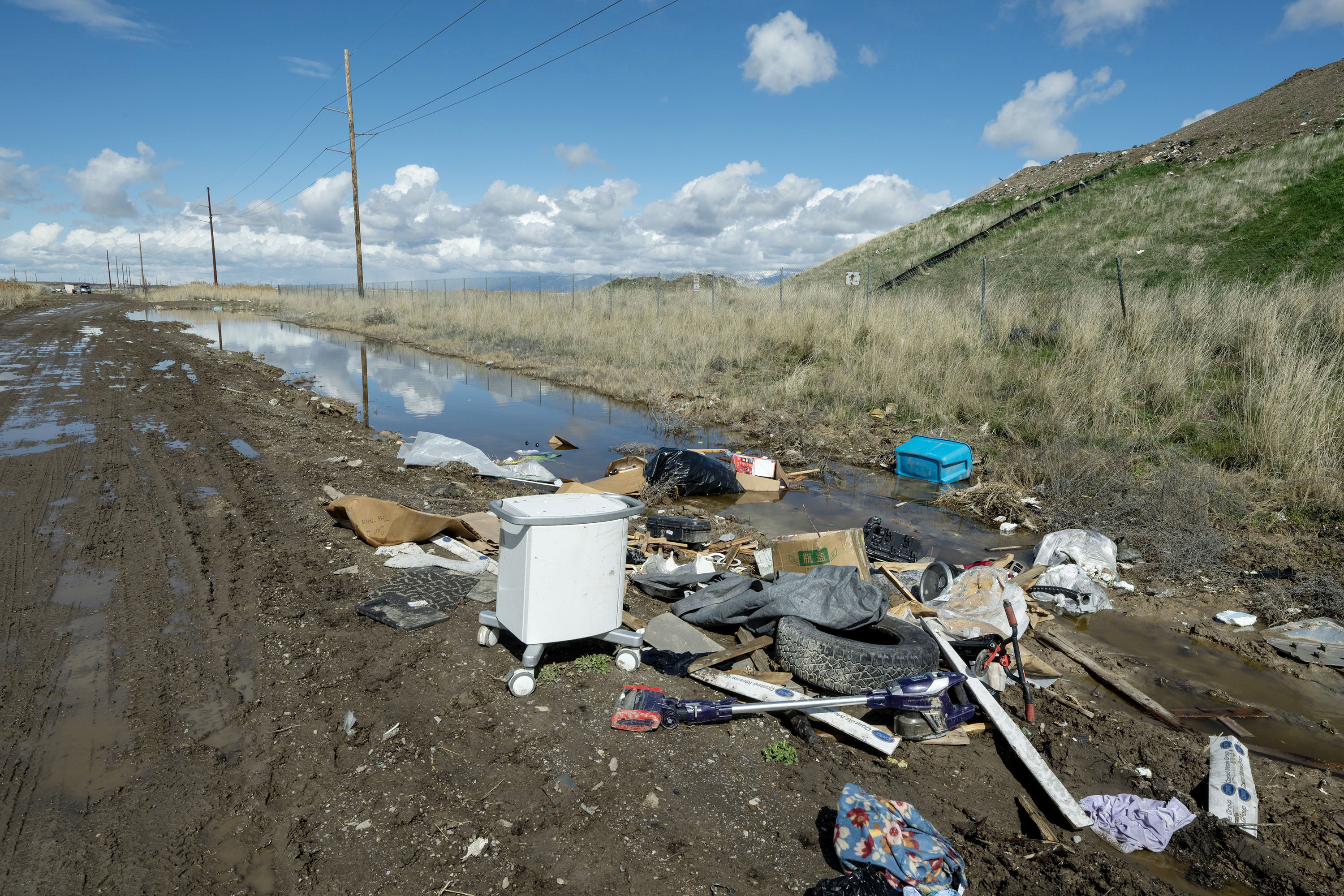 Junk is piled on the side of the road along 7200 West on Monday. Salt Lake City is considering a road closure of 7200 West from I-80 to California Avenue that could last into 2026 because illegal dumping and other issues in and around the area.