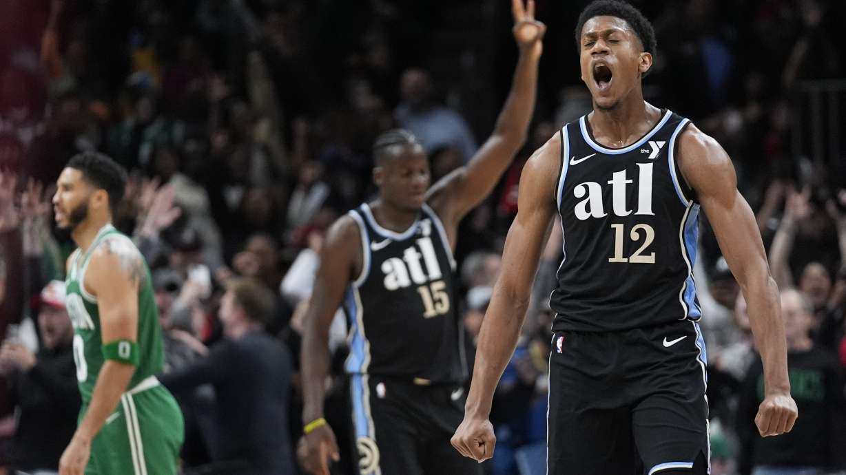 Atlanta Hawks forward De'Andre Hunter (12) reacts after hitting a three-point basket late in the second half of an NBA basketball game against the Boston Celtics Monday, March 25, 2024, in Atlanta. The Hawks won.