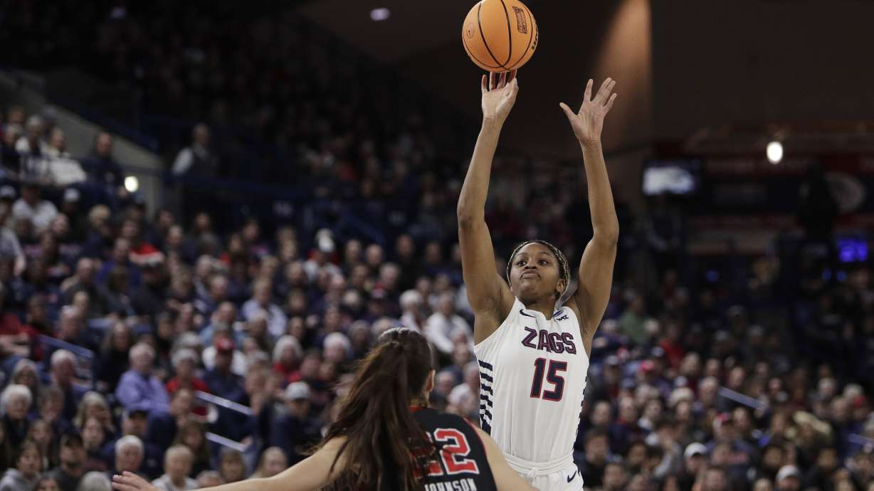 Gonzaga forward Yvonne Ejim (15) shoots while pressured by Utah forward Jenna Johnson during the first half of a second-round college basketball game in the NCAA Tournament in Spokane, Wash., Monday, March 25, 2024.