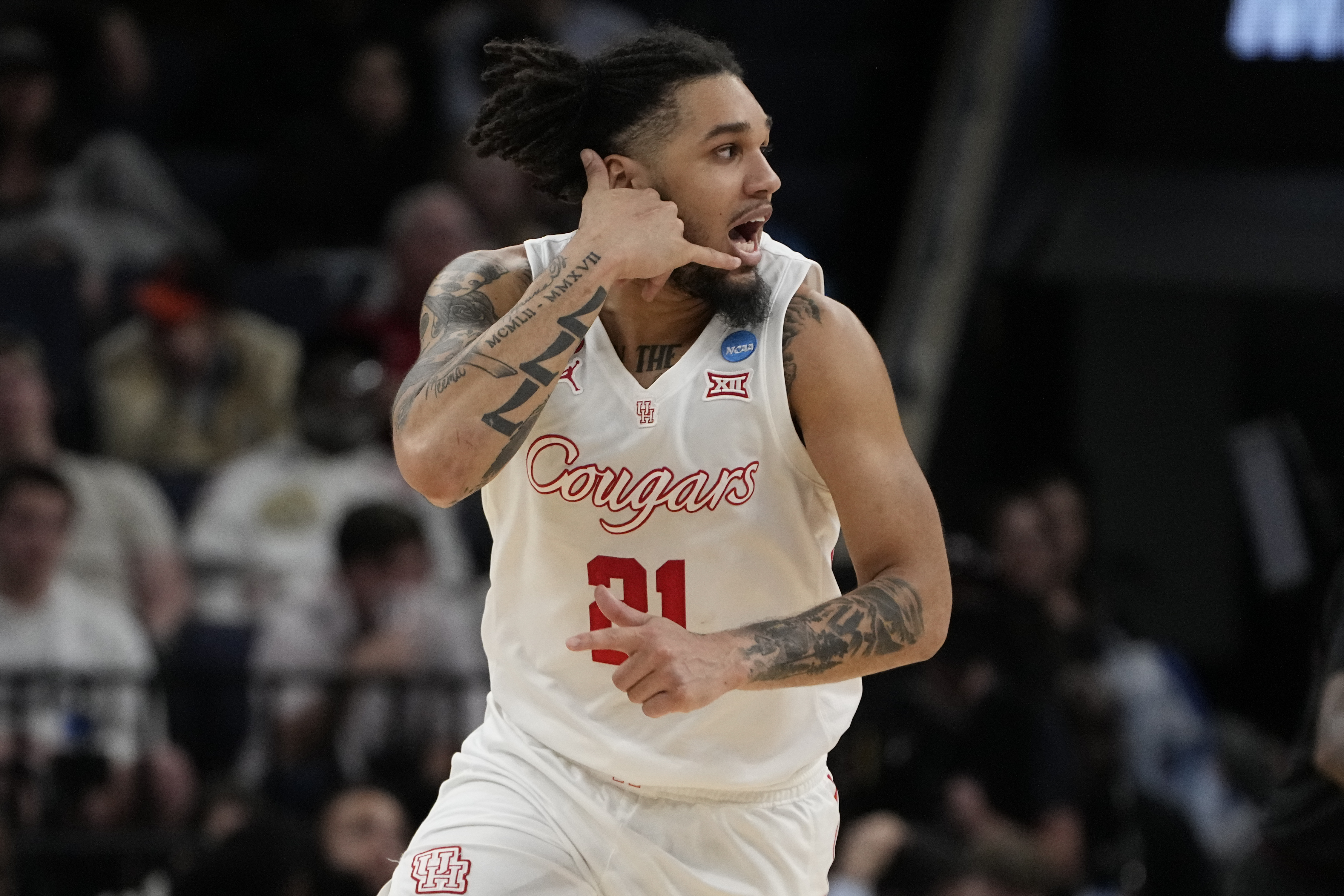 Houston guard Emanuel Sharp (21) celebrates a three-point basket during the second half of a second-round college basketball game against Texas A&M in the NCAA Tournament, Sunday, March 24, 2024, in Memphis, Tenn. Houston won 100-95 in overtime.