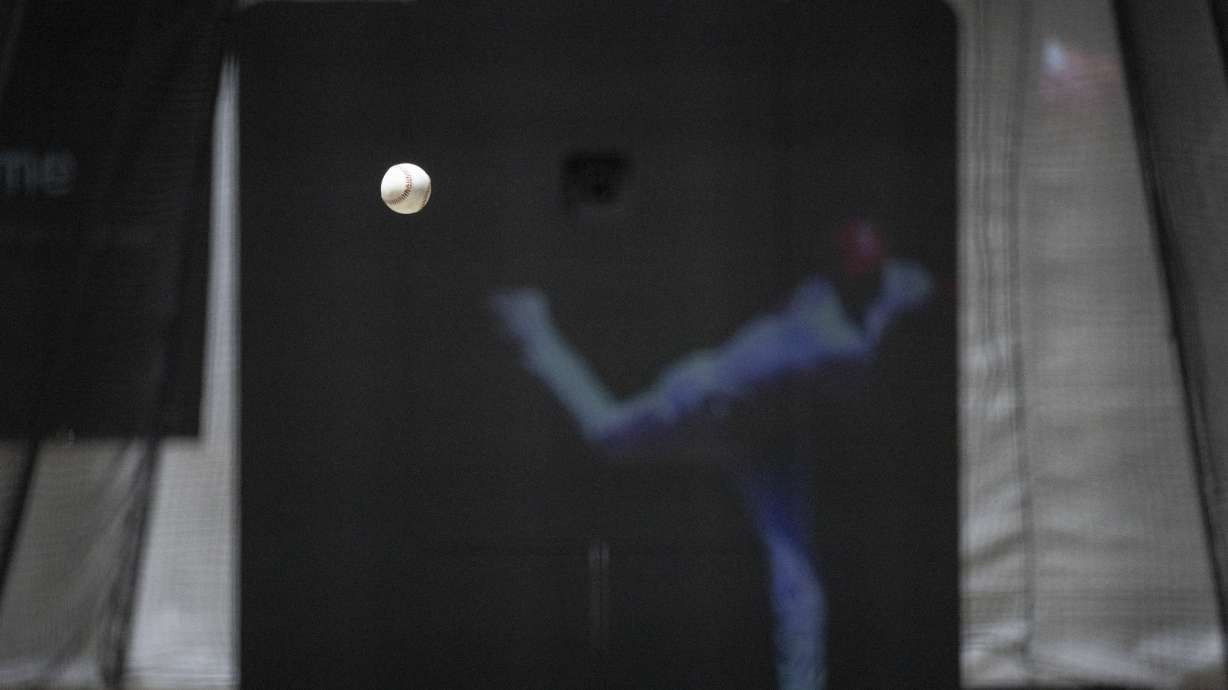 The Trajekt Arc pitching machine is demonstrated during the Major League Baseball winter meetings Wednesday, Dec. 6, 2023, in Nashville, Tenn. Trajekt uses data to mimic the way balls spin and break from big league pitchers and has for the first time been approved by Major League Baseball for in-game use this year in batting cages.