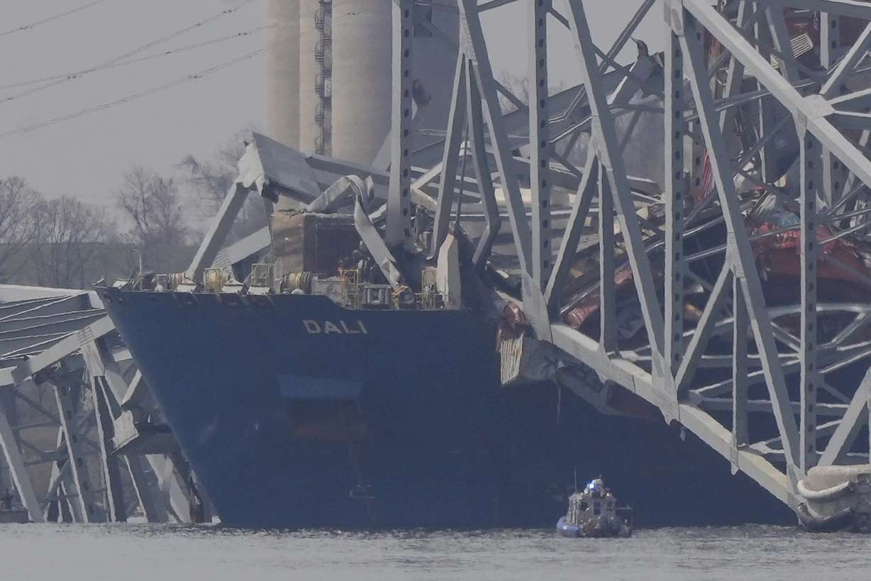 A container rests against wreckage of the Francis Scott Key Bridge Tuesday in Baltimore.
