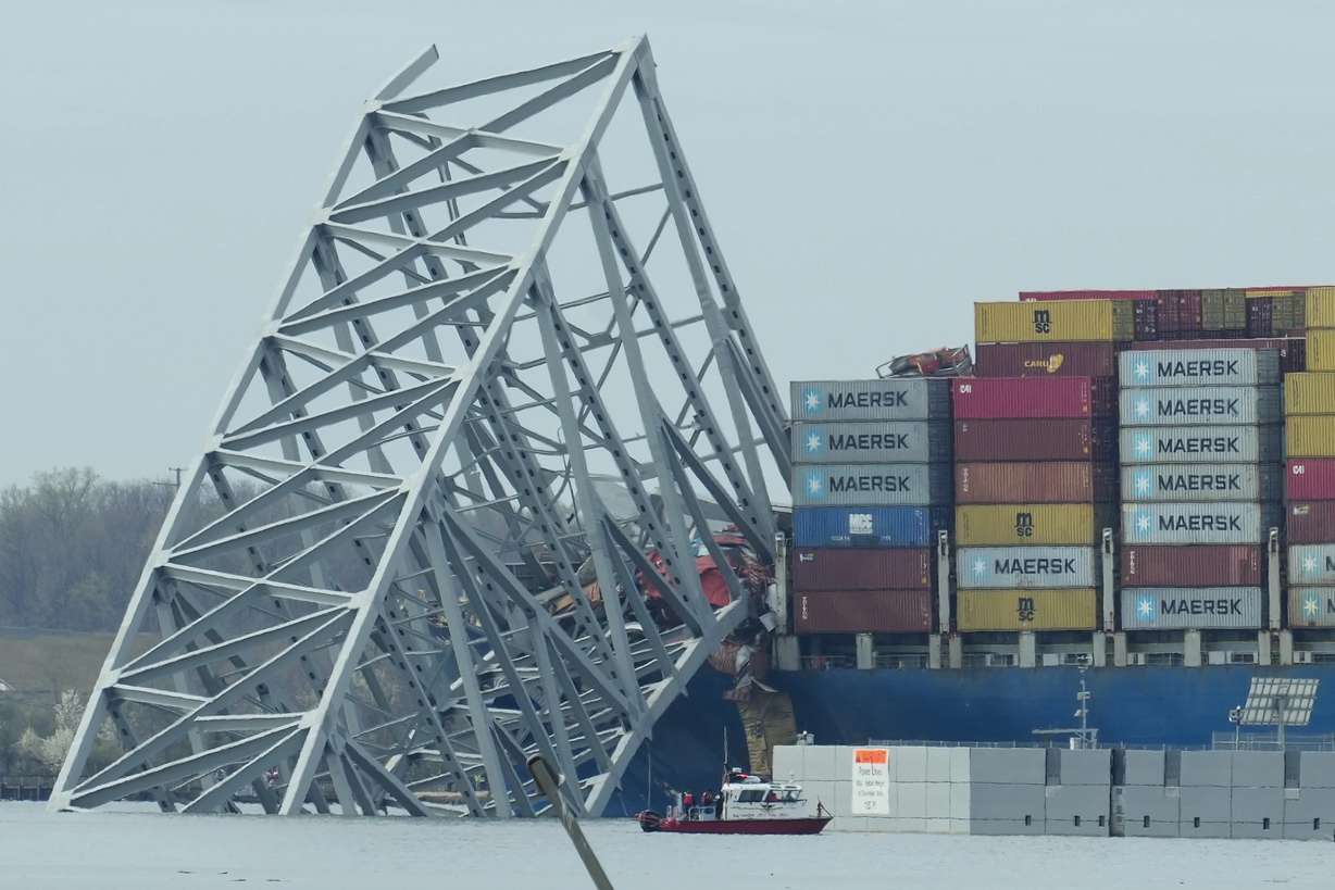 A container ship as it rests against wreckage of the Francis Scott Key Bridge on Tuesday as seen from Dundalk, Md. The ship rammed into the major bridge in Baltimore early Tuesday, causing it to collapse in a matter of seconds and creating a terrifying scene as several vehicles plunged into the chilly river below.