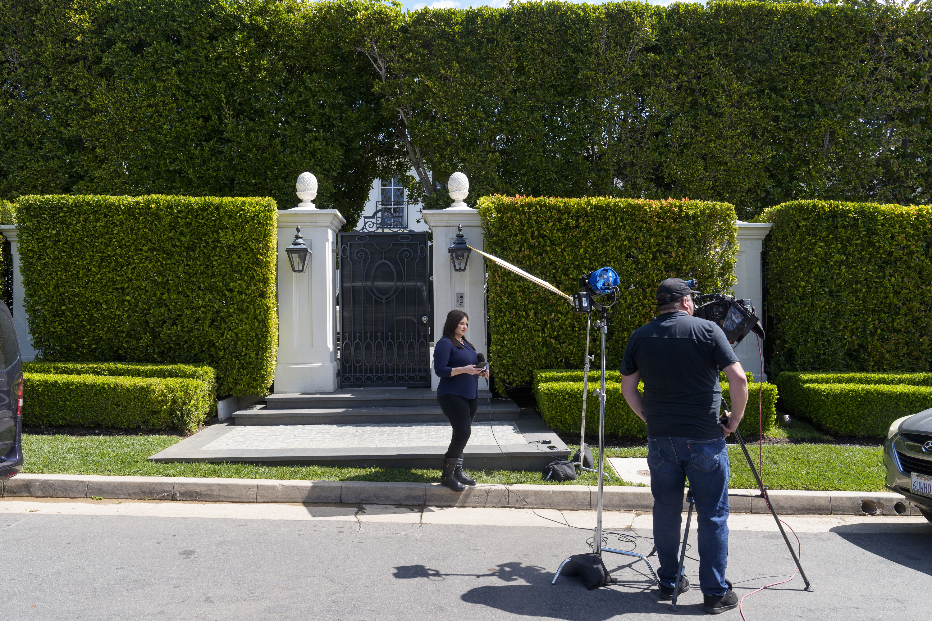 Television crews report live outside a property belonging to Sean "Diddy" Combs, Tuesday in Los Angeles, the day after law enforcement executed a raid as part of an ongoing sex trafficking investigation.