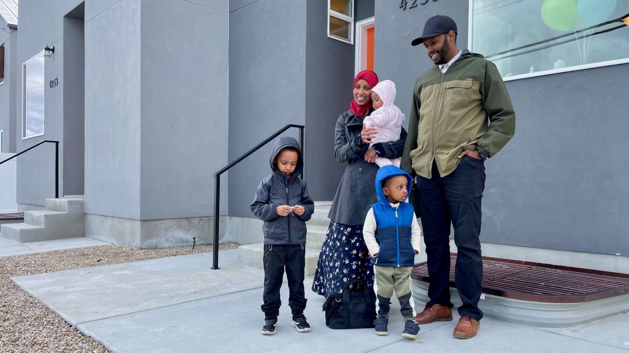 Hassan Sheikh, right, and his family received the keys to their new Salt Lake Valley Habitat for Humanity home at the Field of Dreams community in Kearns on Tuesday. The 20-unit community should be complete and filled by June.