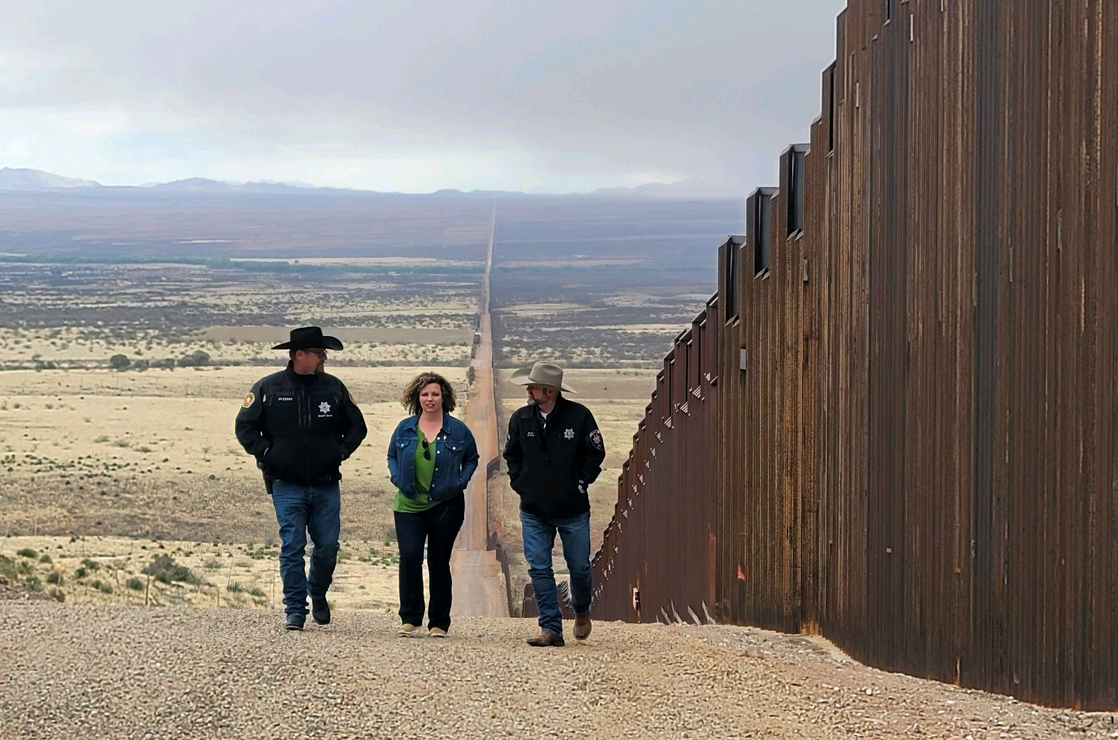 Celeste Maloy, R-Utah, middle, walks along the U.S.-Mexico border with Kane County Sheriff Tracy Glover, left, and Utah County Sheriff Mike Smith, right, Sunday in Cochise County, Arizona.