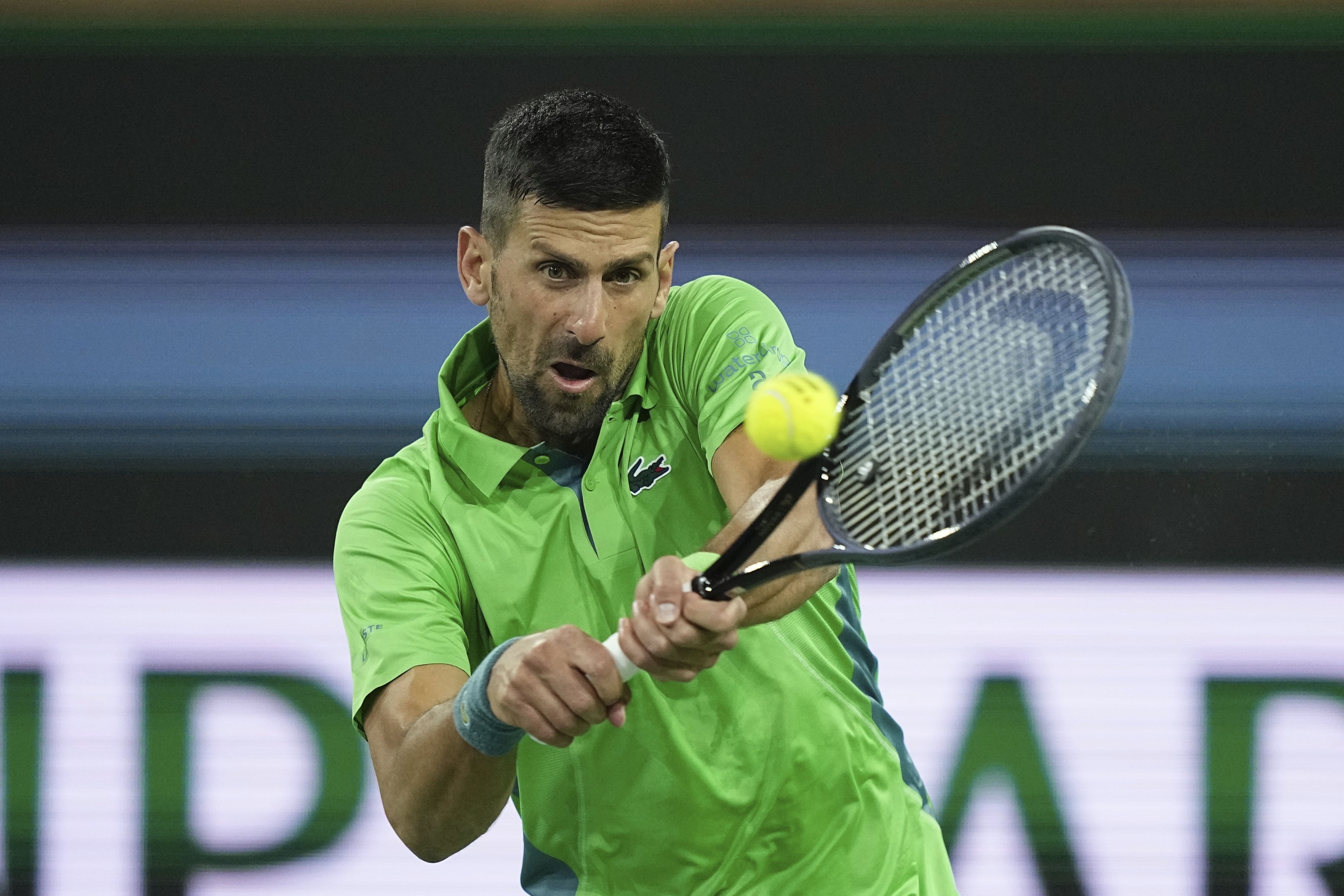 Novak Djokovic, of Serbia, returns a shot Luca Nardi, of Italy, at the BNP Paribas Open tennis tournament Monday, March 11, 2024, in Indian Wells, Calif. Nardi won 6-4, 3-6, 6-3. 