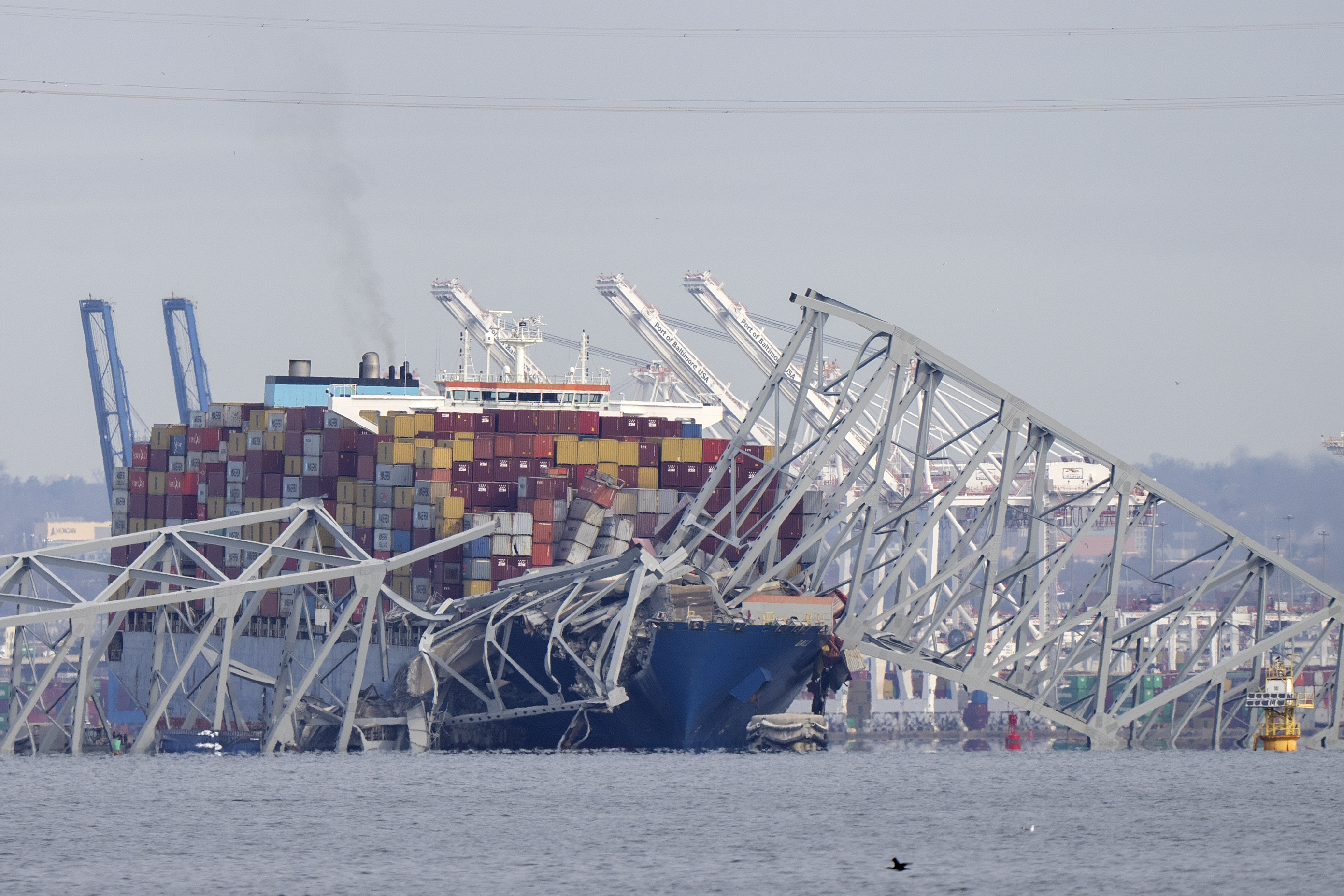 A container ship rests against wreckage of the Francis Scott Key Bridge on Tuesday, as seen from Pasadena, Md.