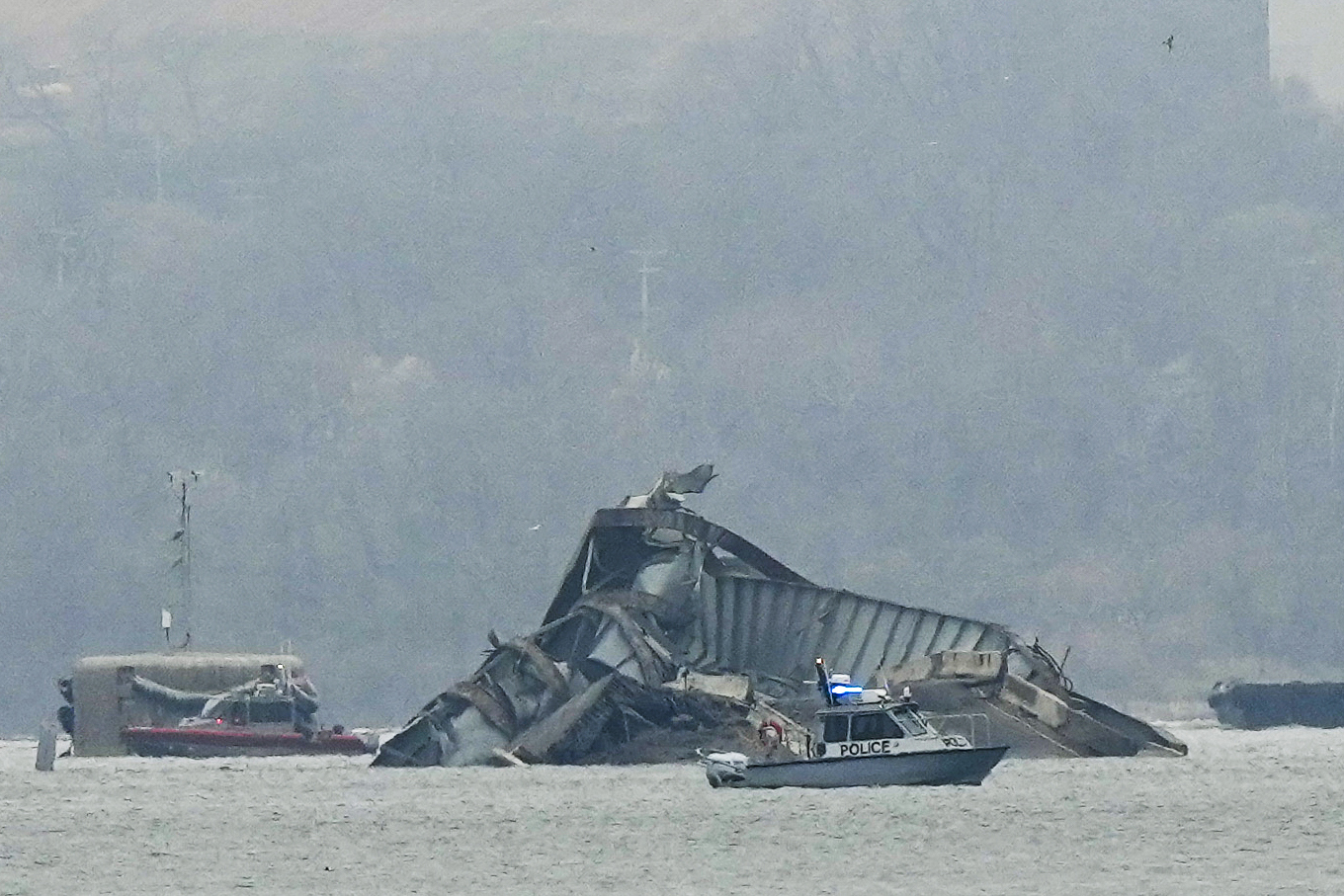 Boats work near wreckage of the Francis Scott Key Bridge on Wednesday in Baltimore, Md.