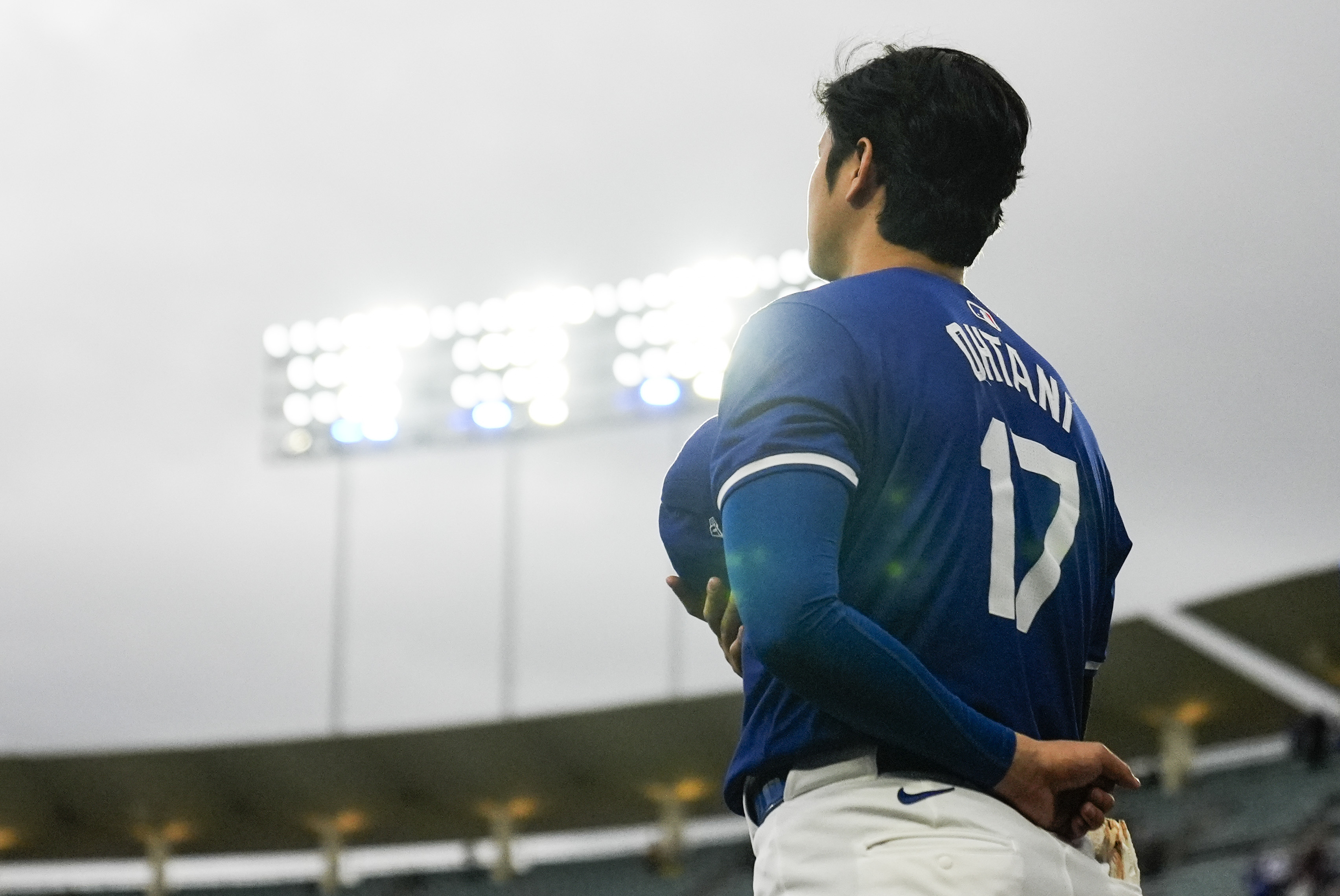 Los Angeles Dodgers designated hitter Shohei Ohtani (17) stands as the national anthem plays before a spring training baseball game against the Los Angeles Angels in Los Angeles, Sunday, March 24, 2024.