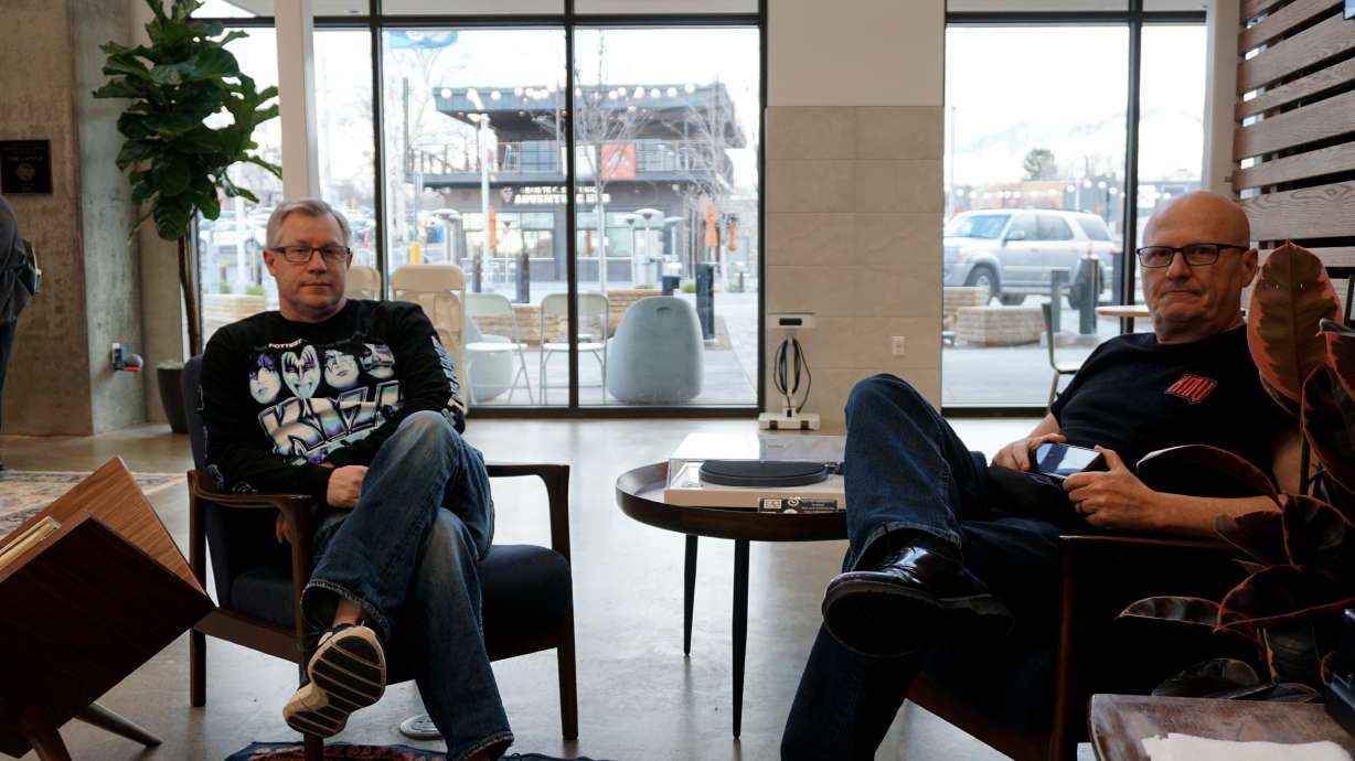 Eric Yuhas and Chris Bowen sit at the vinyl listening section set up at the Millcreek Commons during a vinyl pop-up event on Tuesday. The event features feature spin-offs, special item releases and DJ performances and runs through April 5.