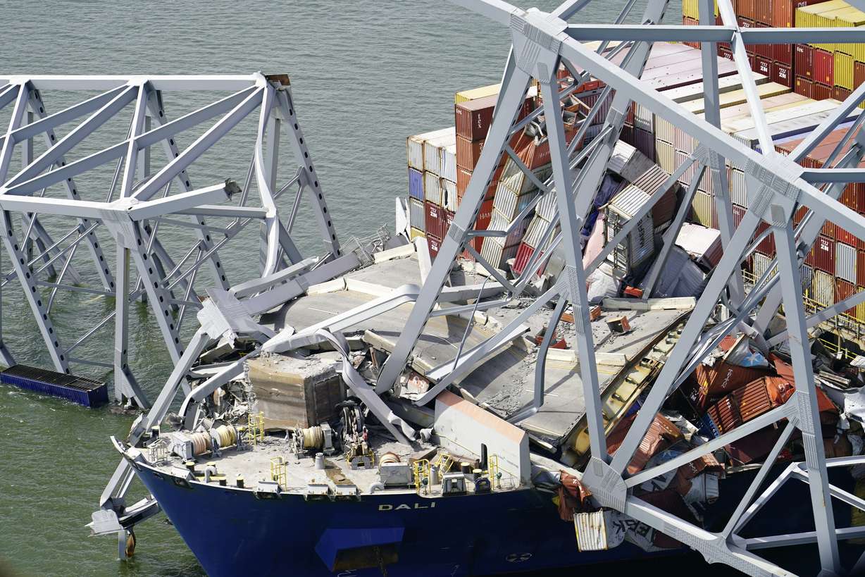 In this aerial image released by the Maryland National Guard, the cargo ship Dali is stuck under the Francis Scott Key Bridge after the ship hit it, Tuesday, in Baltimore.