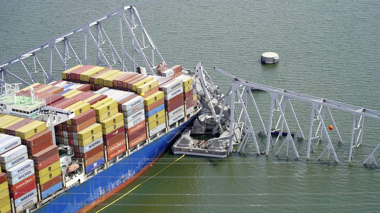 The cargo ship Dali is stuck under part of the structure of the Francis Scott Key Bridge after the ship hit the bridge, Tuesday in Baltimore. The Coast Guard says the ship underwent "routine engine maintenance" in port beforehand.
