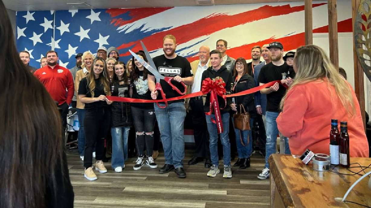Glen Reber gets ready to cut the ribbon in front of city leaders for the official grand opening at The Fellas Barber Shop in Cedar City, March 14. Reber is opening the shop in Cedar City after its first location opened in Utah County several years ago.