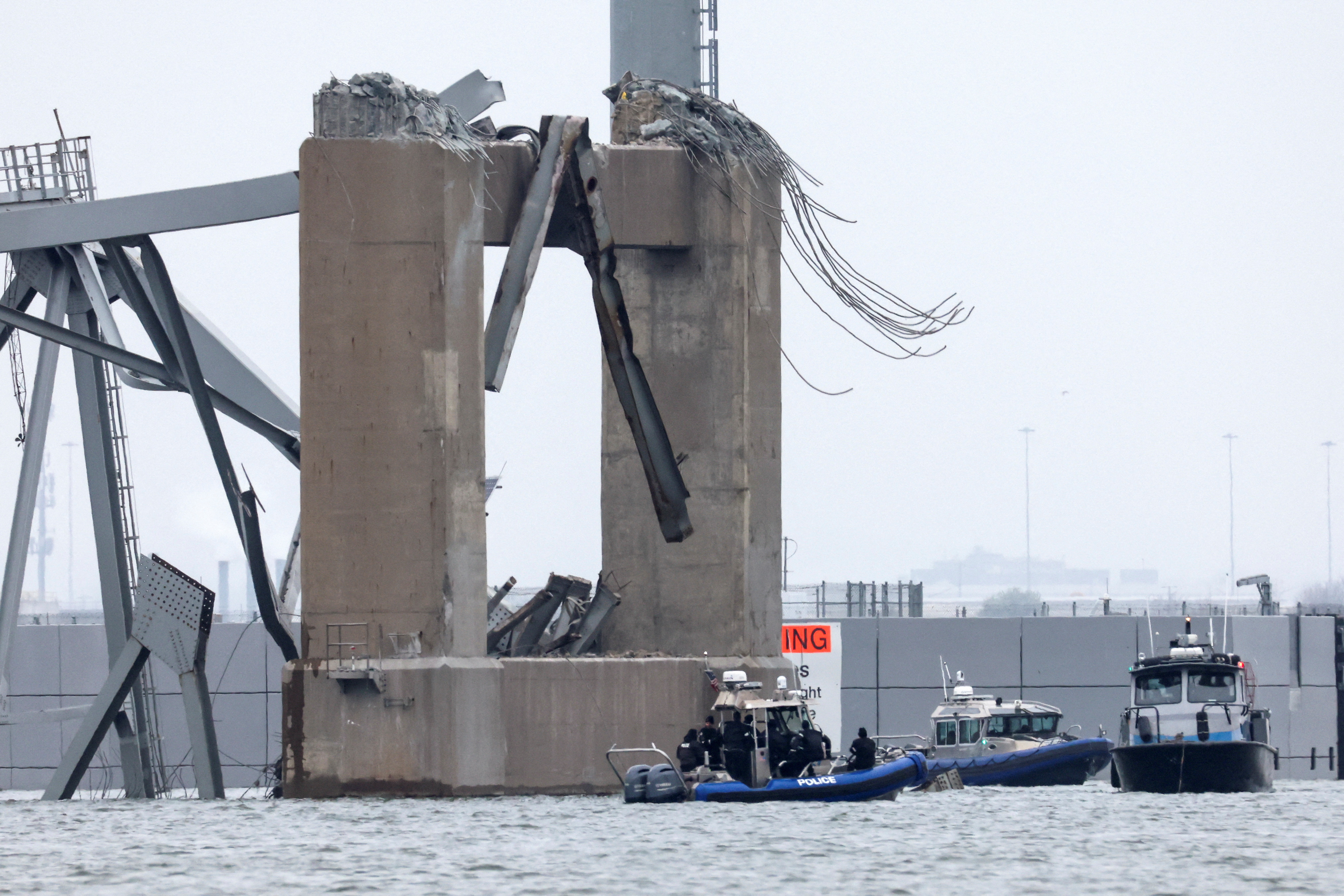 Emergency boats work near the collapsed section of the Francis Scott Key Bridge, after the Dali cargo vessel crashed into it, in Baltimore, Md., Wednesday.
