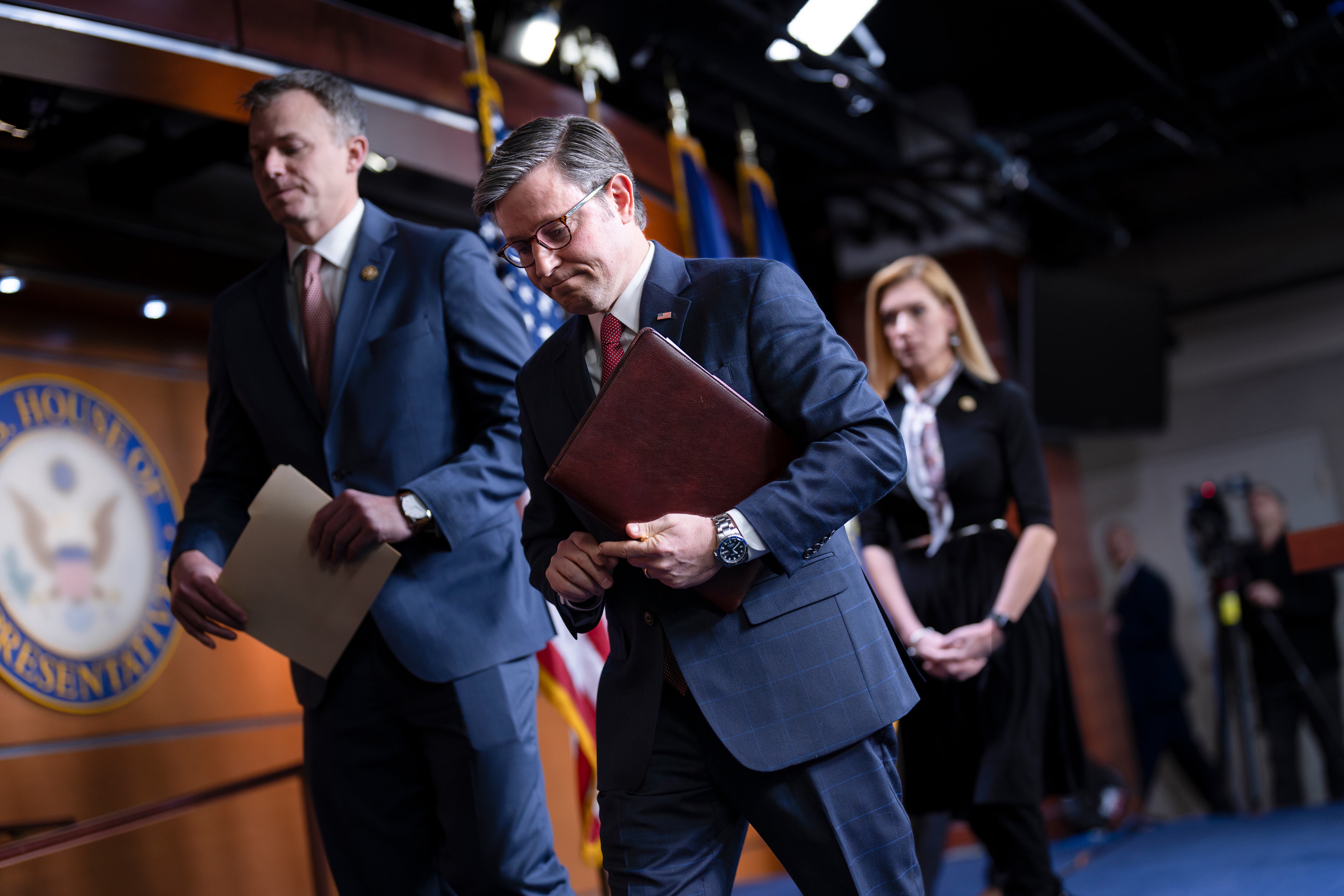 Speaker of the House Mike Johnson, R-La., departs a news conference, joined by Rep. Blake Moore, R-Utah, left, and Rep. Beth Van Duyne, R-Texas, after they discussed President Joe Biden for his policies at the Mexican border during a news conference at the Capitol in Washington, Feb. 29.