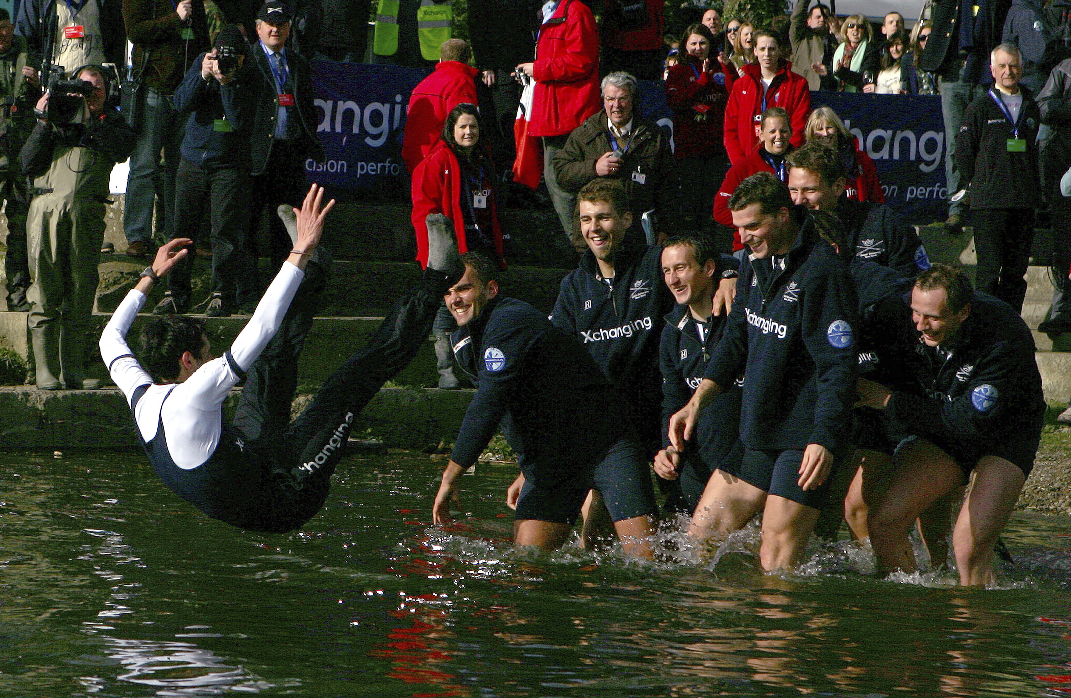 FILE - The Oxford crew, right, throw their cox Colin Groshong into the Thames at the 155th Boat Race, in London, Sunday March 29, 2009. Jumping into London’s River Thames has been the customary celebration for members of the winning crew in the annual Boat Race between storied English universities Oxford and Cambridge. Now researchers say it comes with a health warning. 