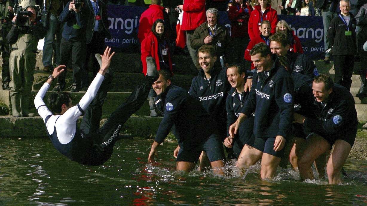 FILE - The Oxford crew, right, throw their cox Colin Groshong into the Thames at the 155th Boat Race, in London, Sunday March 29, 2009. Jumping into London’s River Thames has been the customary celebration for members of the winning crew in the annual Boat Race between storied English universities Oxford and Cambridge. Now researchers say it comes with a health warning.