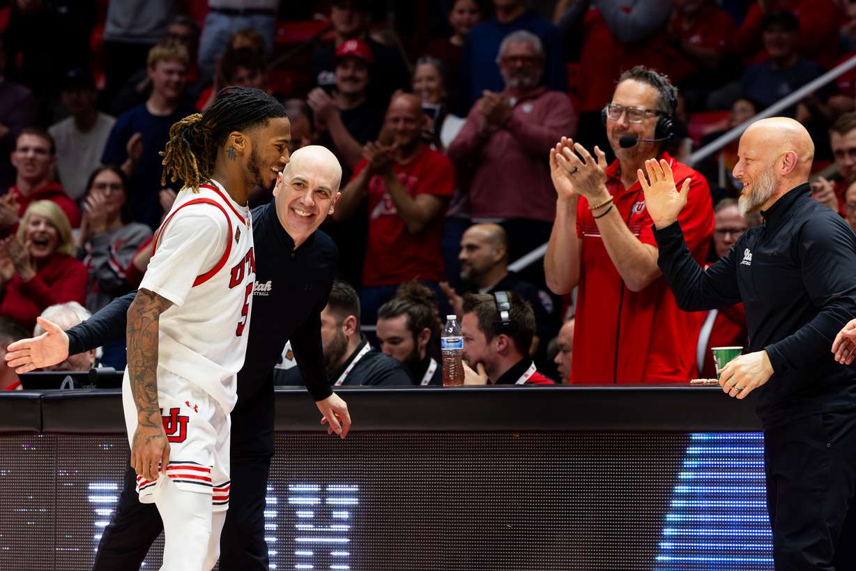 Utah Utes head coach Craig Smith hugs Utah Utes guard Deivon Smith (5) as he comes off the court for the final time during the NIT quarterfinal game between the Utah Utes and the Virginia Commonwealth Rams at the Jon M. Huntsman Center in Salt Lake City on Wednesday, March 27, 2024. The Utah Utes won the game 74-54.
