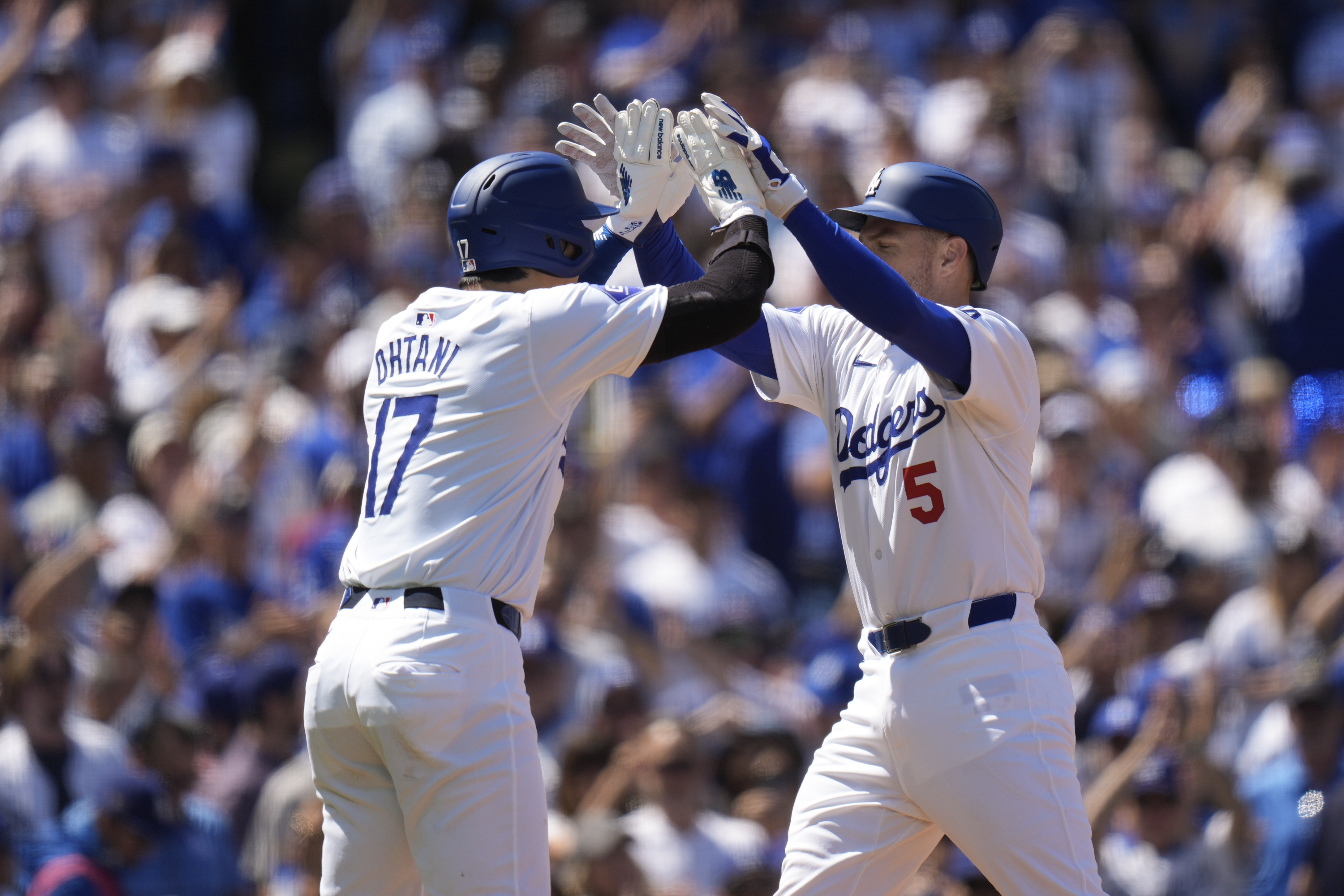 Los Angeles Dodgers' Freddie Freeman (5) celebrates his two-run home run with Shohei Ohtani during the third inning of a baseball game against the St. Louis Cardinals Thursday, March 28, 2024, in Los Angeles.