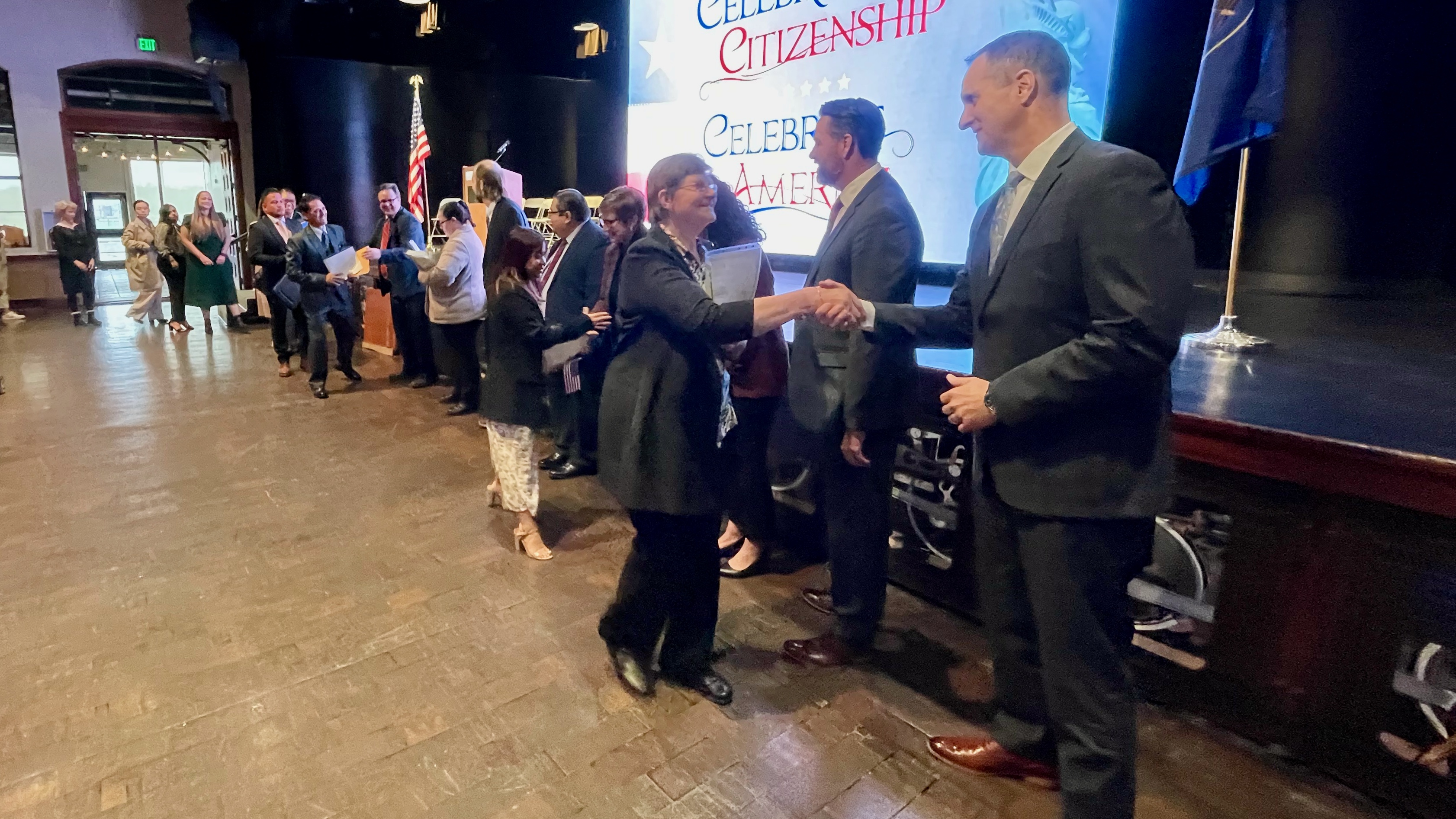 Ogden Mayor Ben Nadolski, right, and other officials greet a contingent of newly naturalized U.S. citizens at a ceremony Thursday in Ogden. The 126 who were naturalized came from 38 countries.