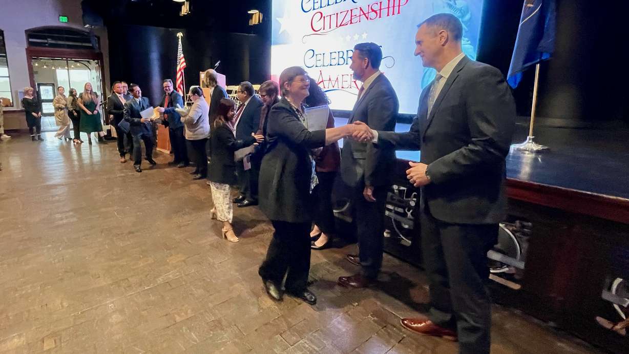 Ogden Mayor Ben Nadolski, right, and other officials greet a contingent of newly naturalized U.S. citizens at a ceremony Thursday in Ogden. The 126 who were naturalized came from 38 countries.