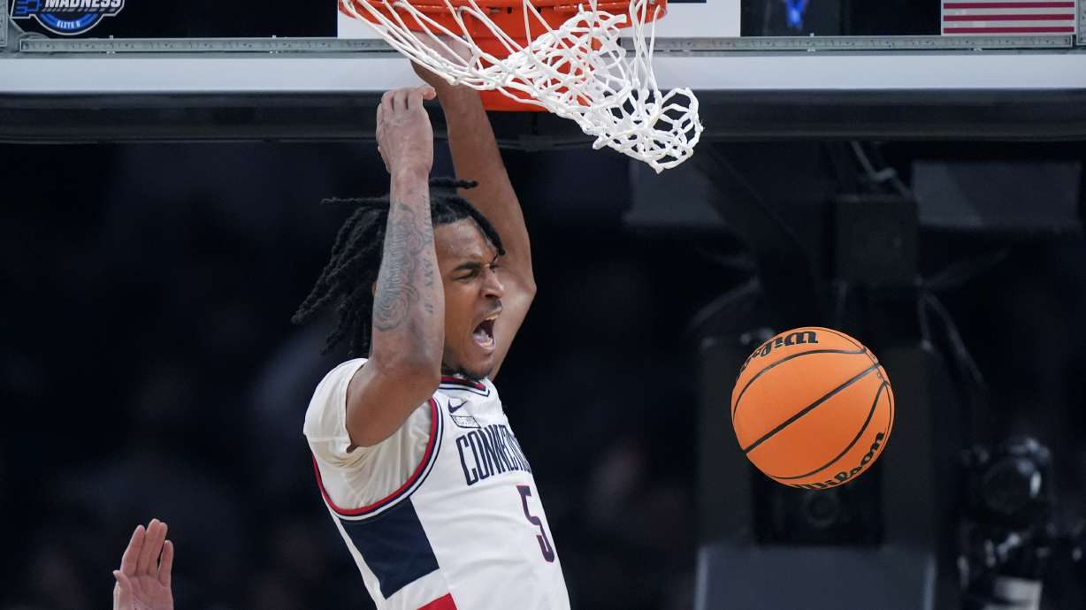 UConn guard Stephon Castle (5) roars while dunking against San Diego State during the second half of the Sweet 16 college basketball game in the men's NCAA Tournament, Thursday, March 28, 2024, in Boston.