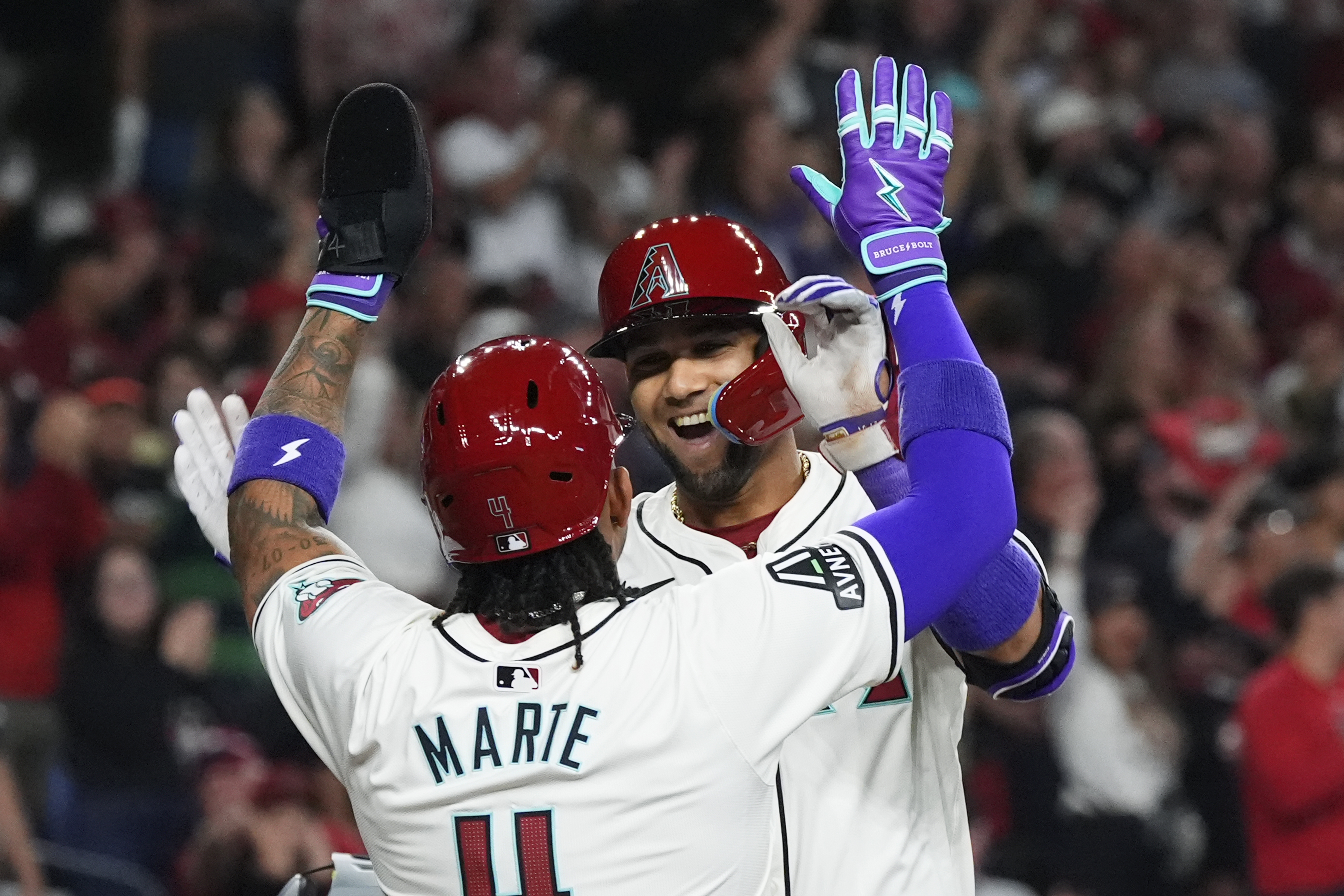 Arizona Diamondbacks' Lourdes Gurriel Jr., rear, celebrates his two-run home run against the Colorado Rockies with Ketel Marte during the first inning of a baseball game Thursday, March 28, 2024, in Phoenix.