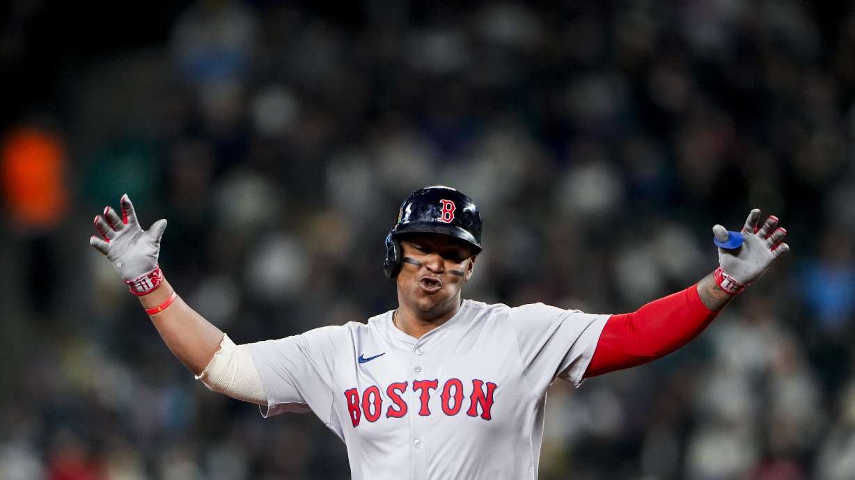 Boston Red Sox's Rafael Devers gestures while running the bases on a two-run home run against the Seattle Mariners during the third inning of an opening-day baseball game Thursday, March 28, 2024, in Seattle.