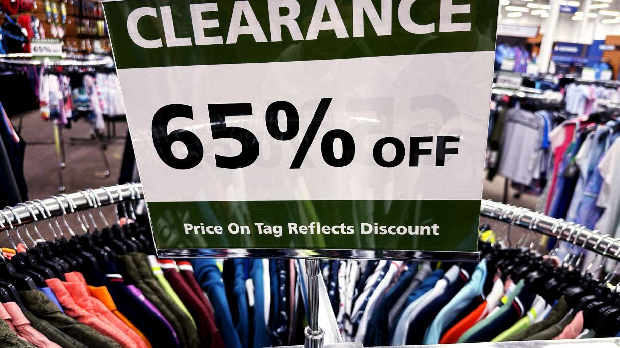 A clearance sign is displayed at a retail clothing store in Downers Grove, Ill., March 12. On Friday, the government issues its latest monthly report on the Federal Reserve’s preferred inflation gauge.