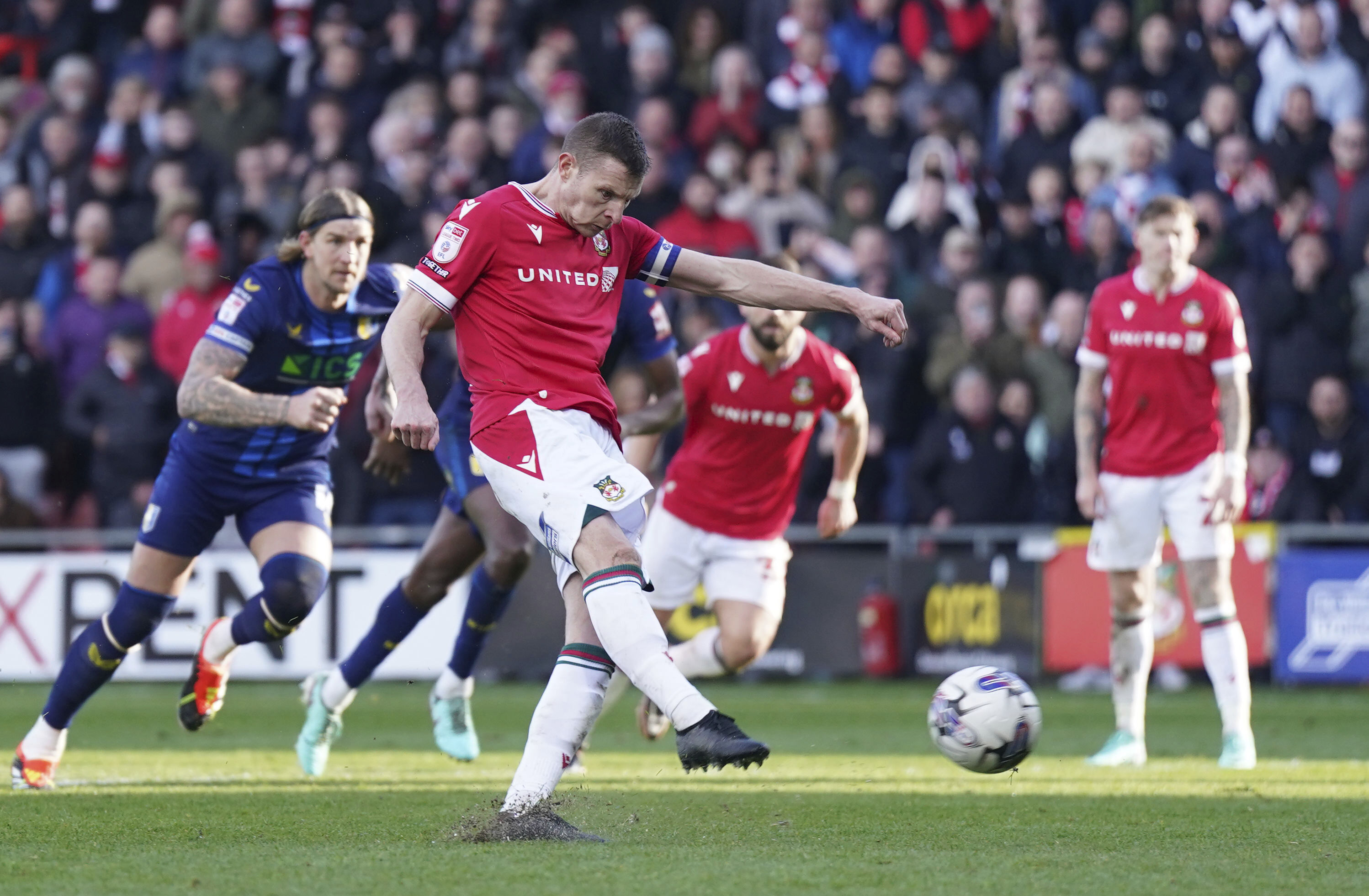 Wrexham's Paul Mullin scores their side's second goal from the penalty spot during the English League Two soccer match between Wrexham and Mansfield Town at the SToK Cae Ras in Wrexham, Wales, Friday, March 29, 2024.