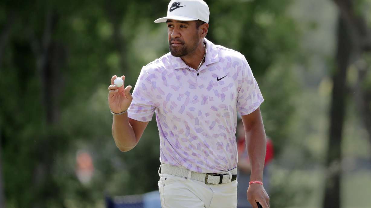 Defending champion Tony Finau acknowledges the gallery after sinking his putt on the eighth green during the first round of the Houston Open golf tournament Thursday, March, 28, 2024, in Houston.