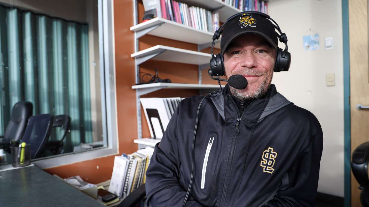 Tony Parks poses for a photo in the broadcast booth after the Salt Lake Bees named him the team's radio voice in November 2023.