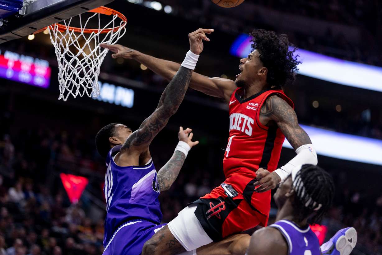 Houston Rockets guard Jalen Green (4) is blocked by Utah Jazz forward John Collins (20) during a game at the Delta Center in Salt Lake City on Friday, Mar 29, 2024.