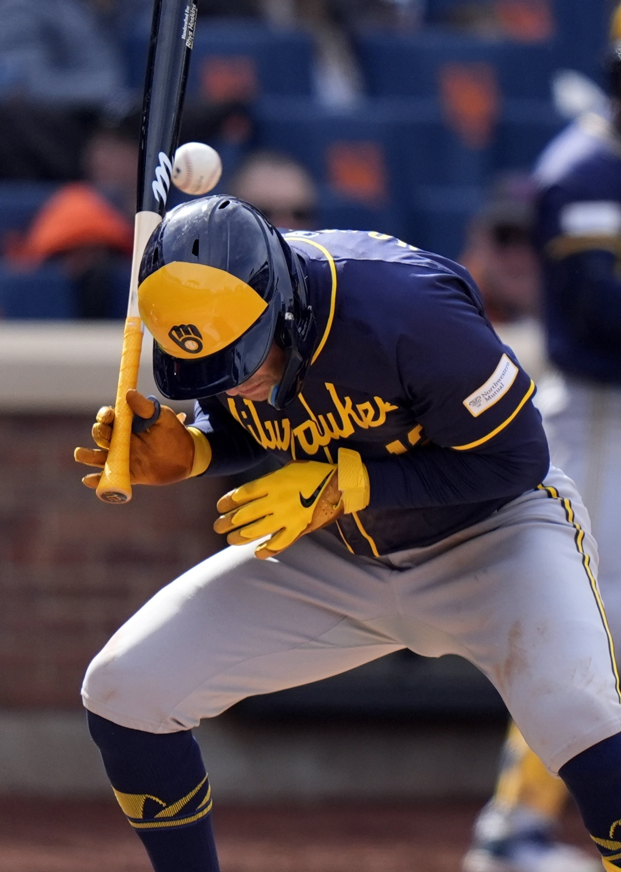 Milwaukee Brewers' Rhys Hoskins (12) ducks a pitch from New York Mets relief pitcher Yohan Ramirez during the seventh inning of a baseball game Saturday, March 30, 2024, in New York. Ramirez was ejected from the game.