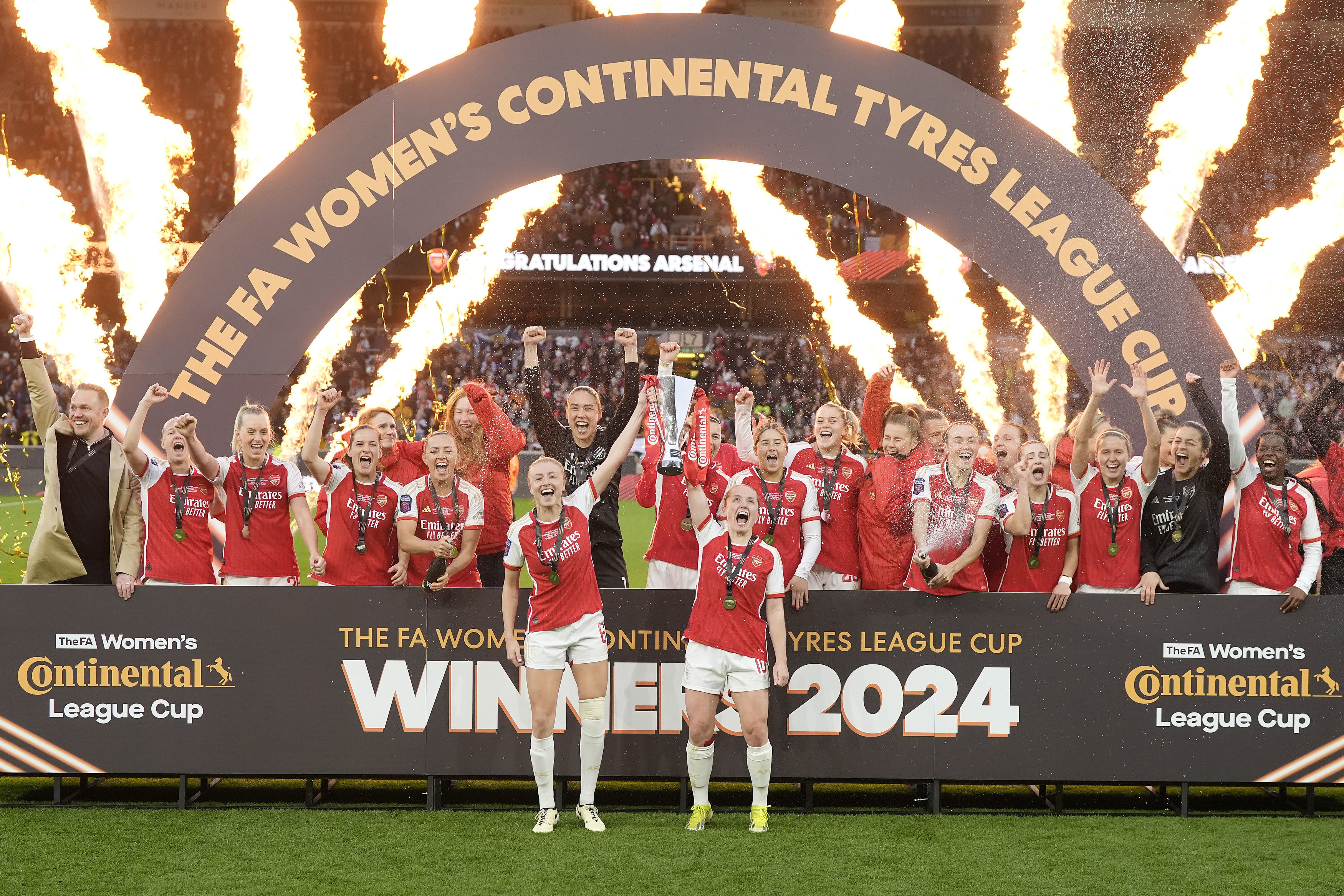 Arsenal's Leah Williamson, front left, and Kim Little, front right, lift the trophy after winning the FA Women's Continental Tyres League Cup Final soccer match between Arsenal and Chelsea at Molineux Stadium, Wolverhampton, England, Sunday March 31, 2024.