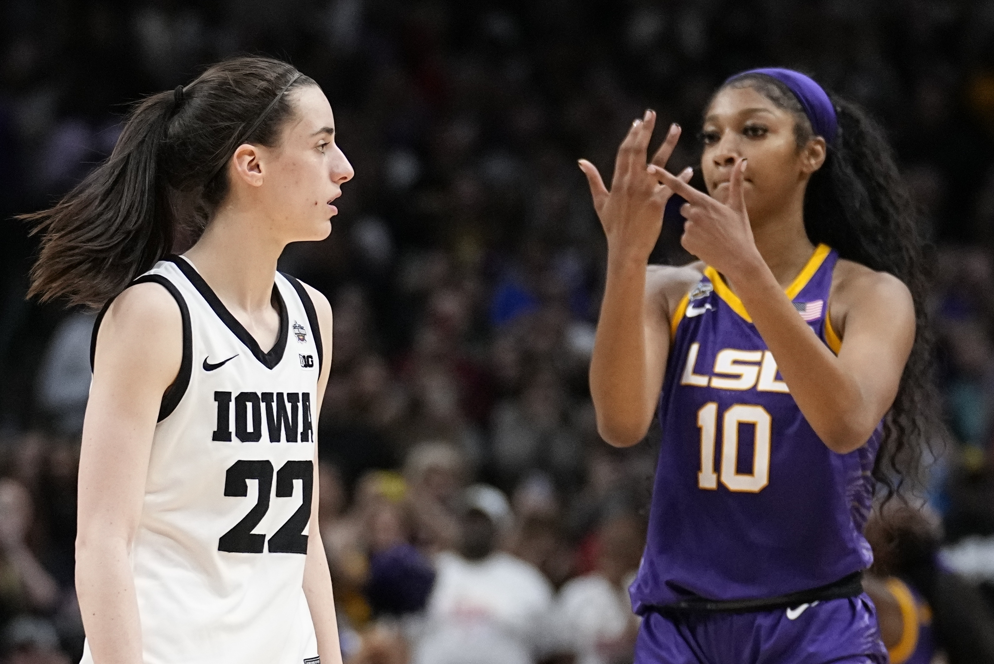 FILE -LSU's Angel Reese reacts in front of Iowa's Caitlin Clark during the second half of the NCAA Women's Final Four championship basketball game April 2, 2023, in Dallas. Iowa and LSU are getting ready to meet again in a rematch of the 2023 national championship game on Monday, April 1, 2024. 