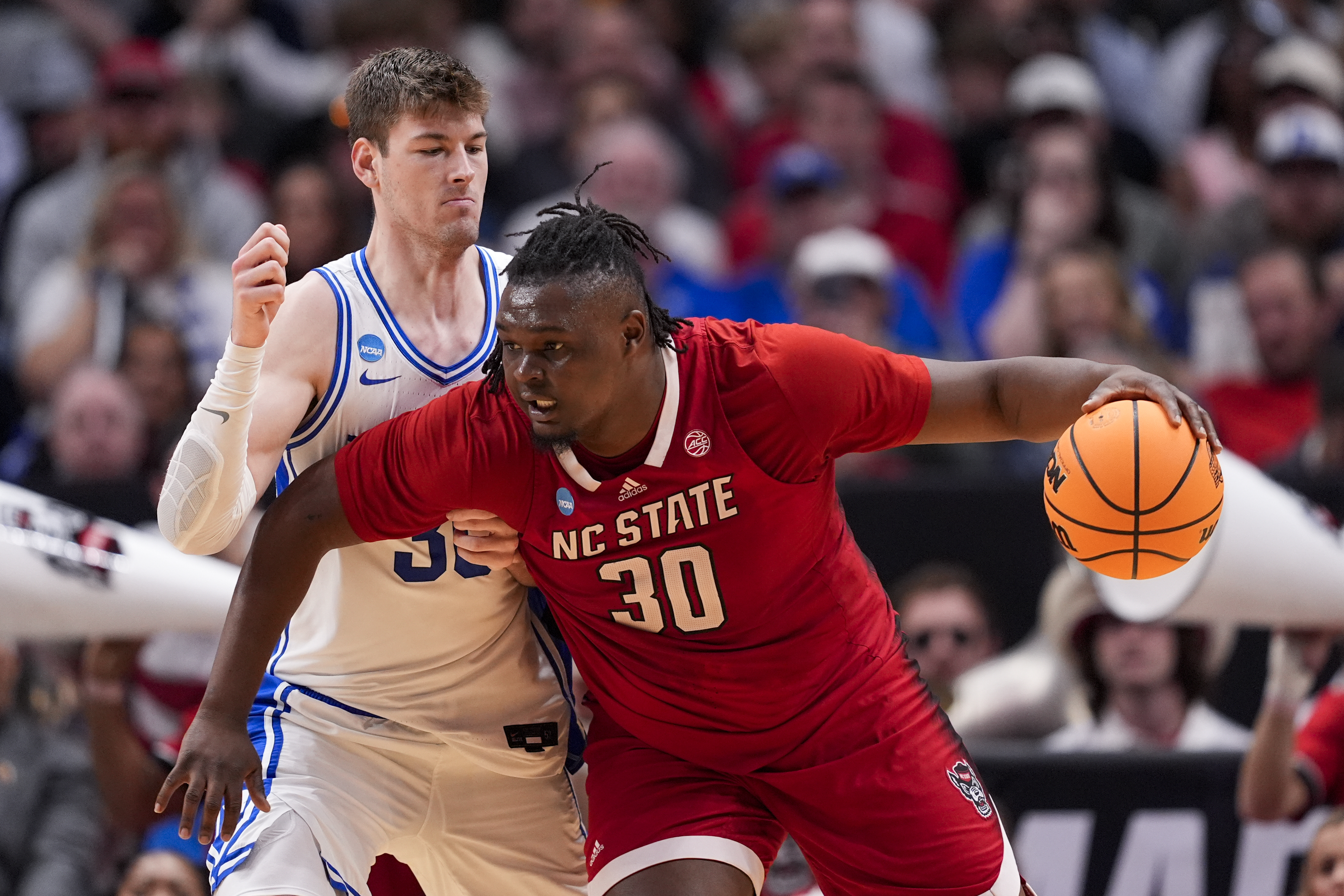 North Carolina State's DJ Burns Jr., right, works the floor against Duke's Kyle Filipowski during the second half of an Elite Eight college basketball game in the NCAA Tournament in Dallas, Sunday, March 31, 2024.