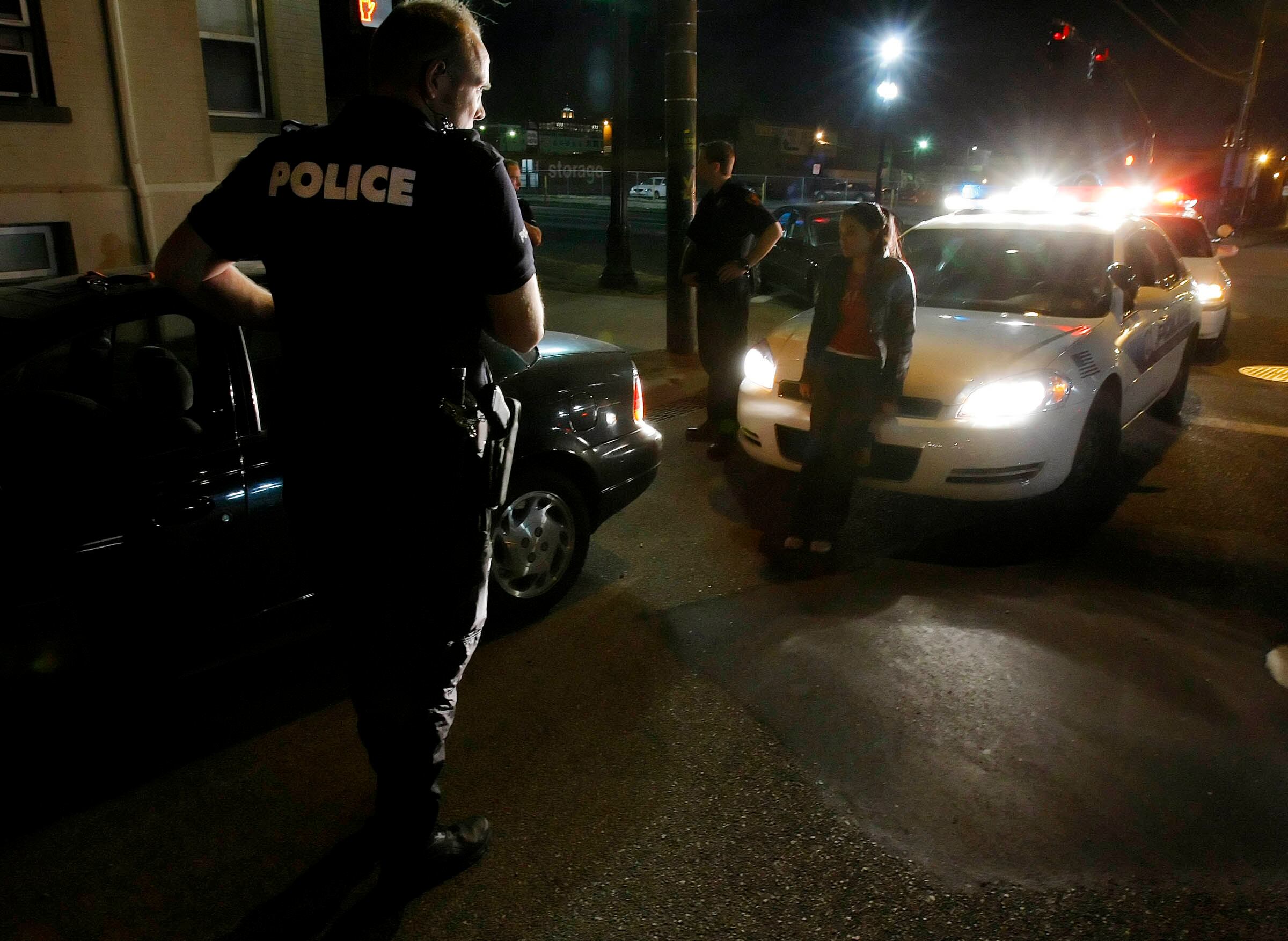 Salt Lake City police and ICE agents arrest drug dealers and work to process any who may be in the country illegally on Nov. 8, 2007.